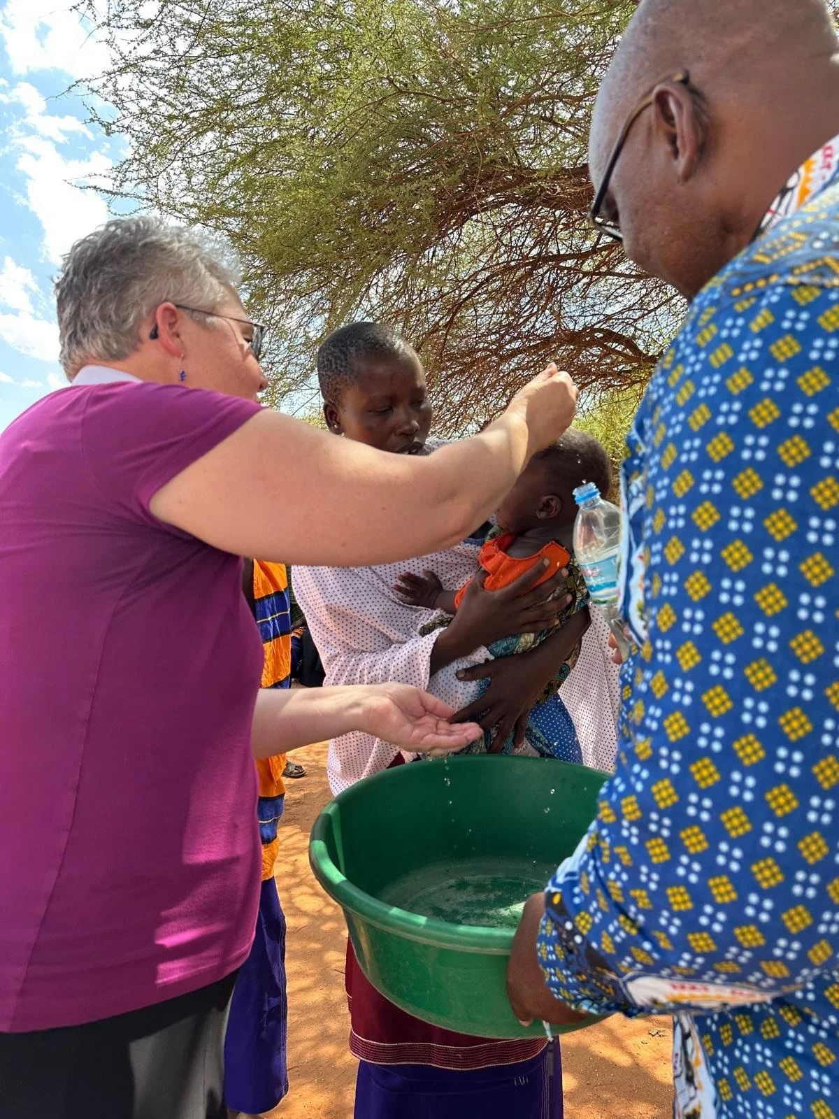 Bishop Current, Pastor Kiseven, Mama, and newly baptized Amy, child of God.