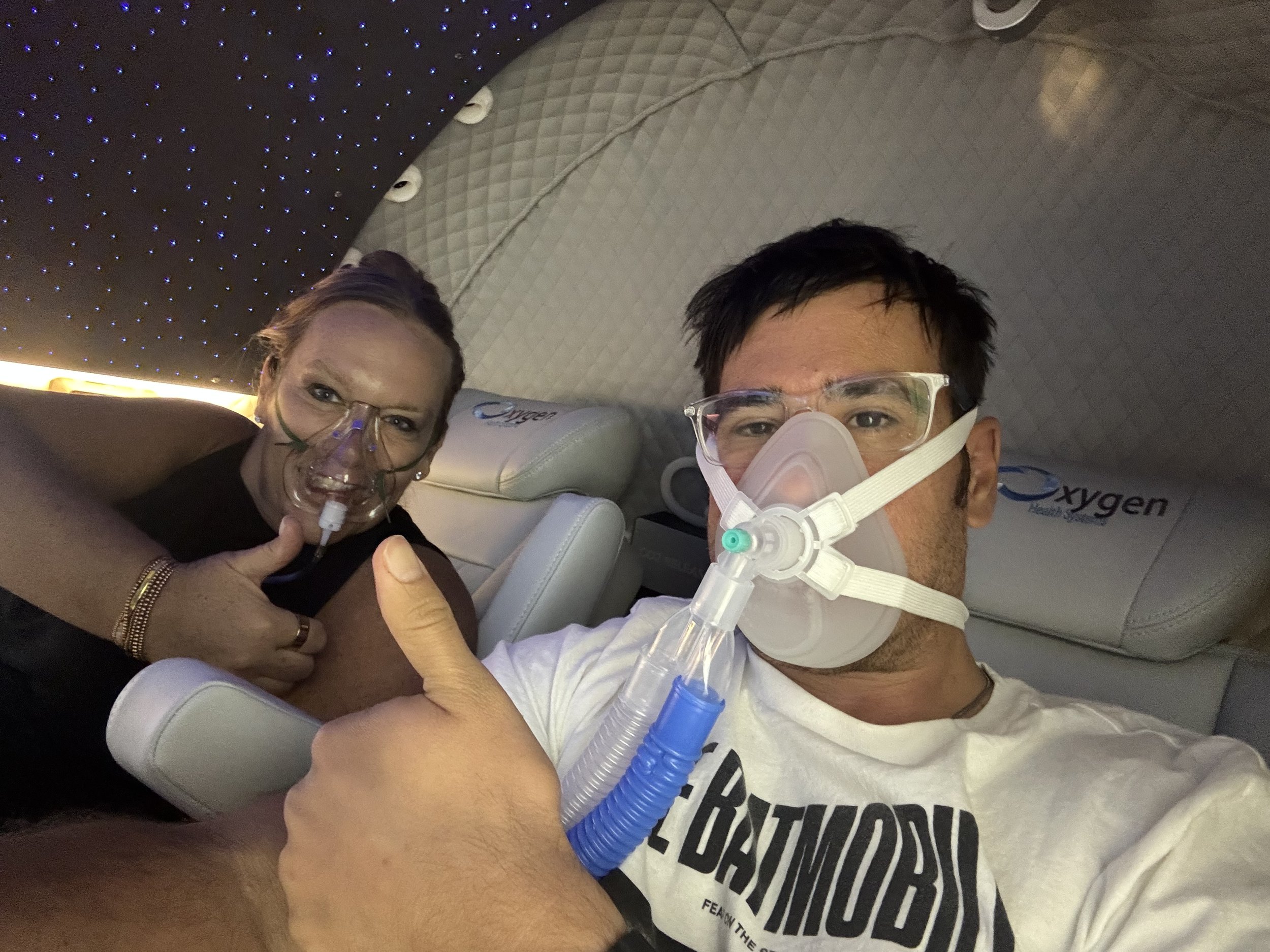 two patients receiving Hyperbaric Oxygen Therapy inside a specialized machine at The Lyday Center in Green Bay, WI