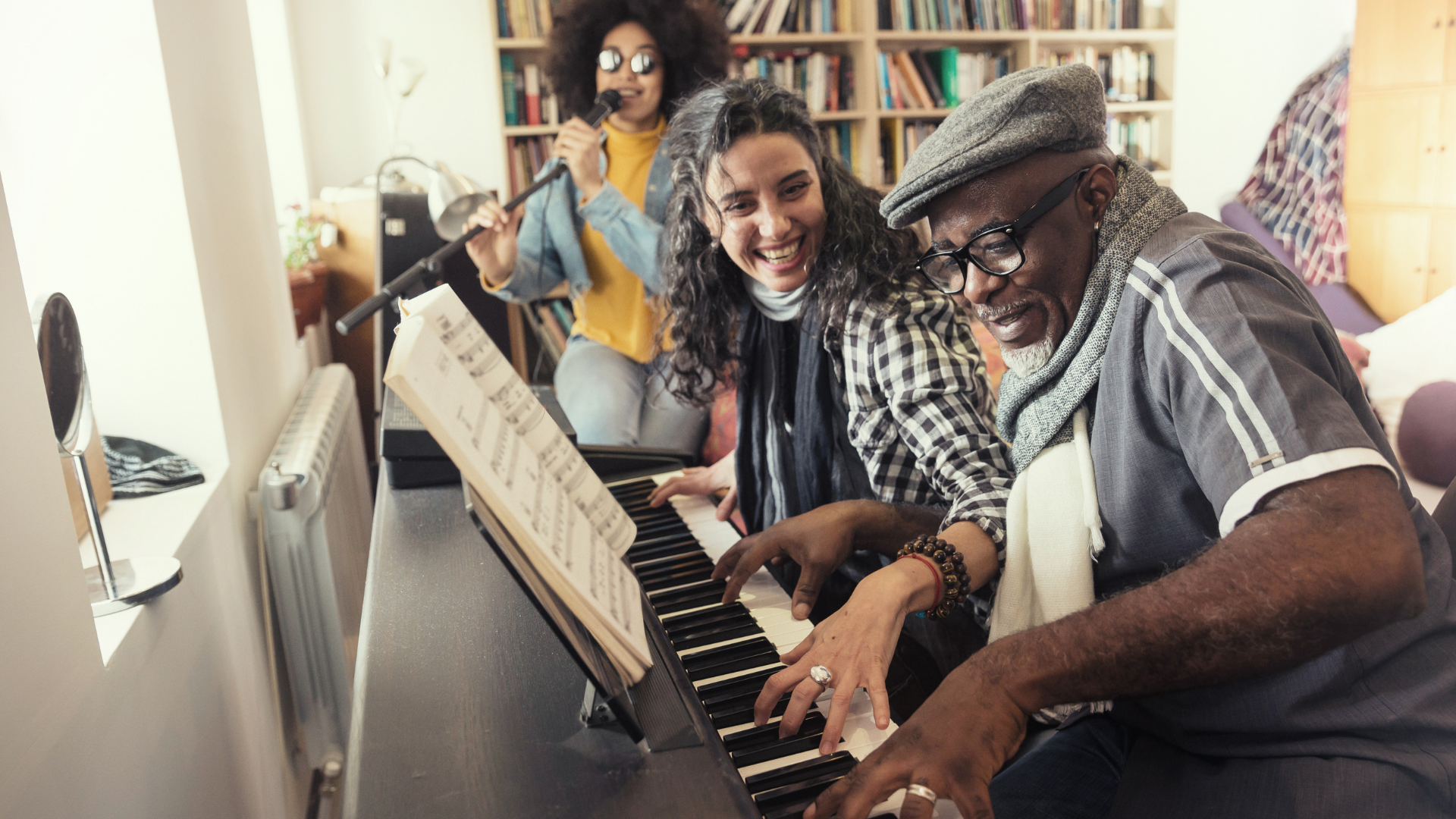 Multigenerational friends singing and playing piano together at home