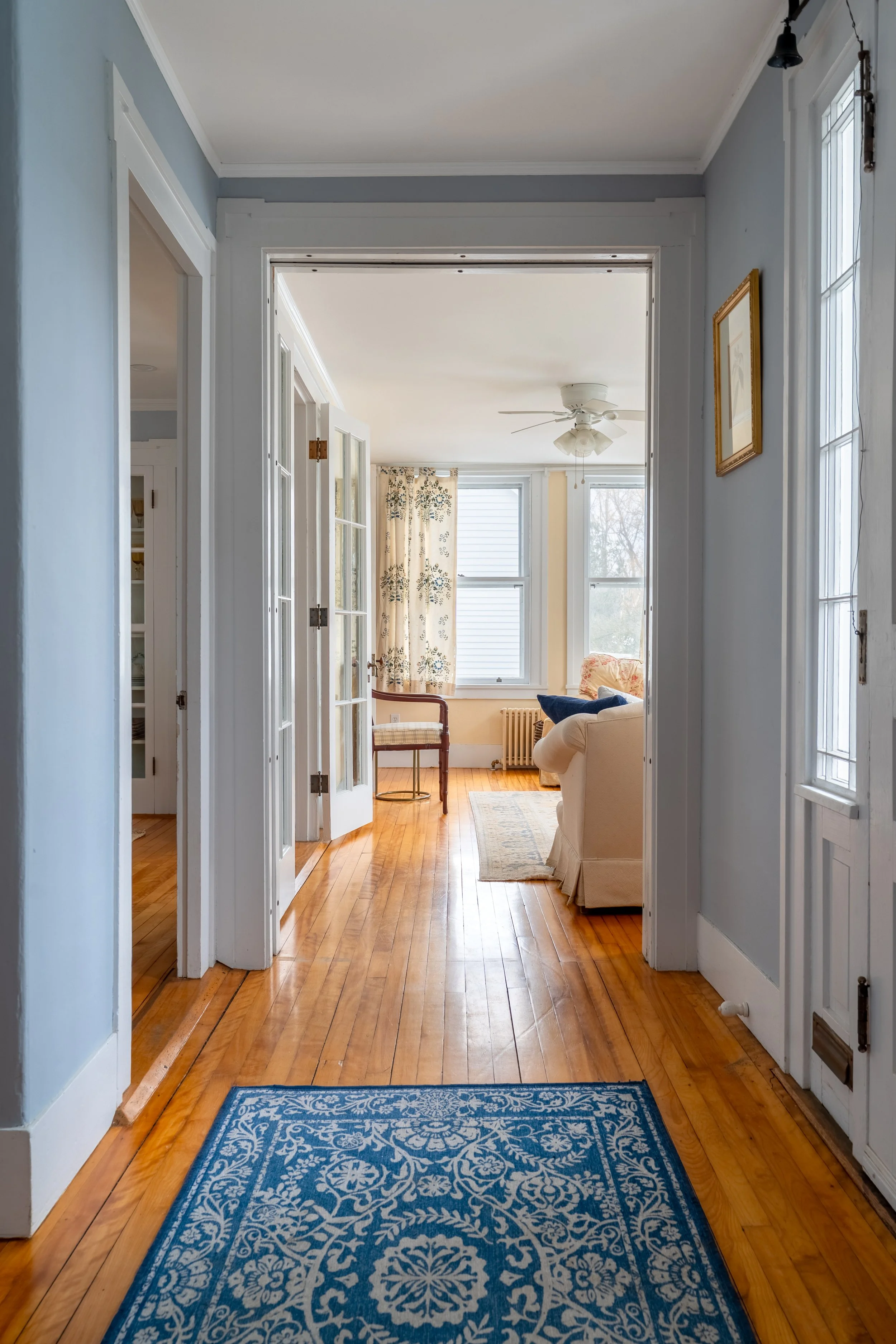 Light-filled sitting room at Three Sisters House in Camden, Maine.