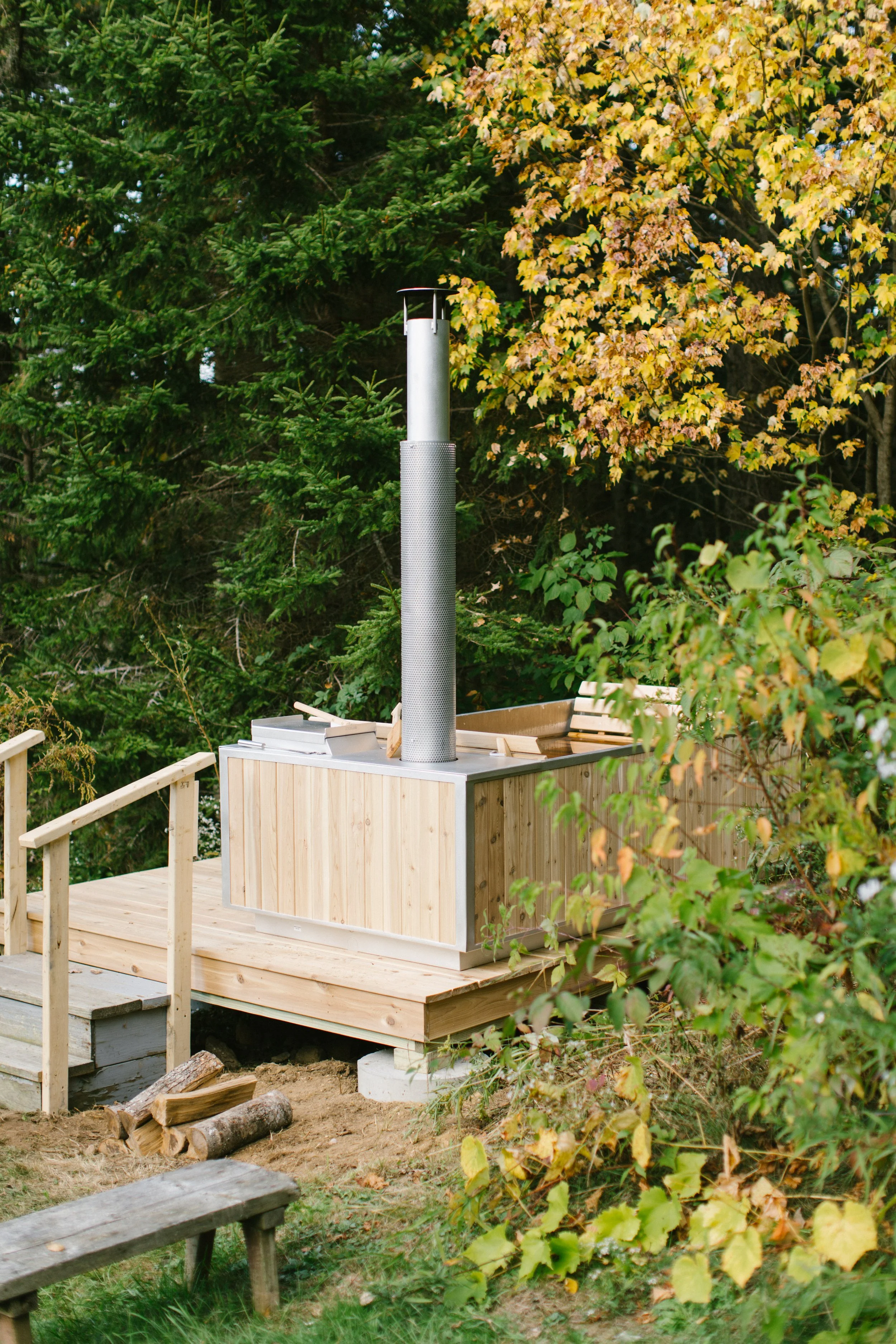 The wood-fired hot tub at Three Sisters Farm, set among the trees on eleven private acres.