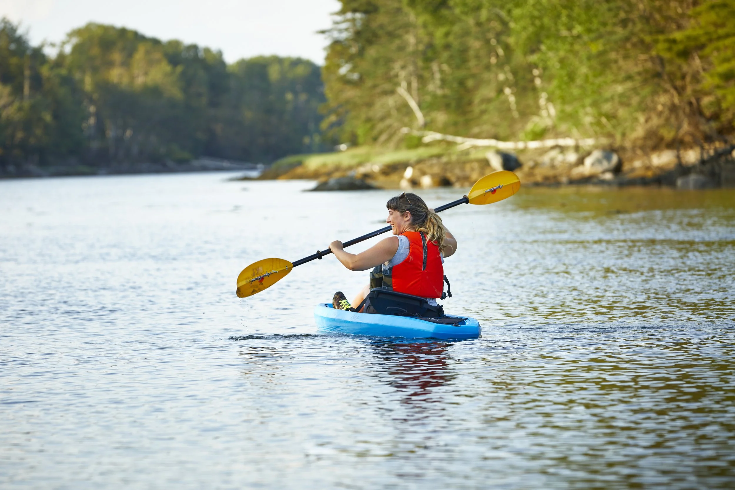 A woman in a kayak down at the tidal cove in Friendship, Maine.