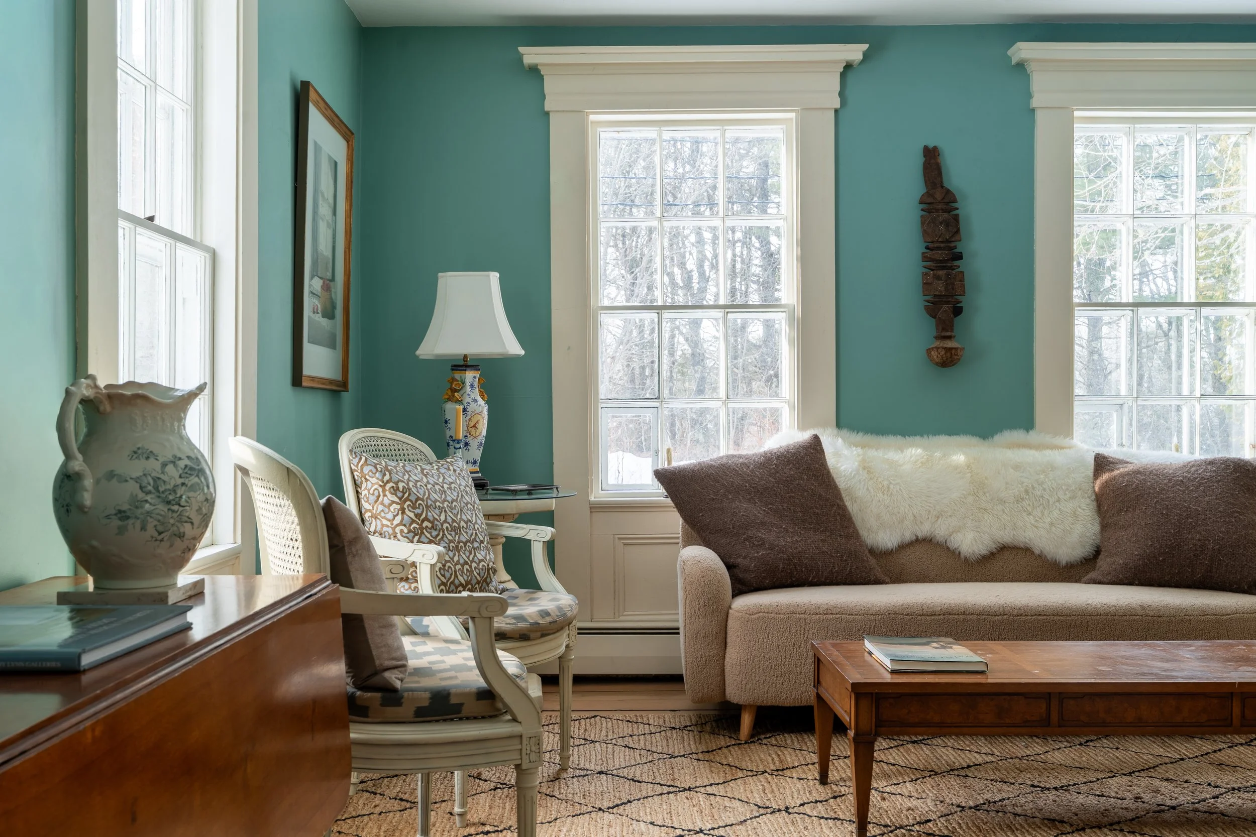 Light-filled formal living room at Three Sisters Farm, an 1850s farmhouse in Friendship, Maine.