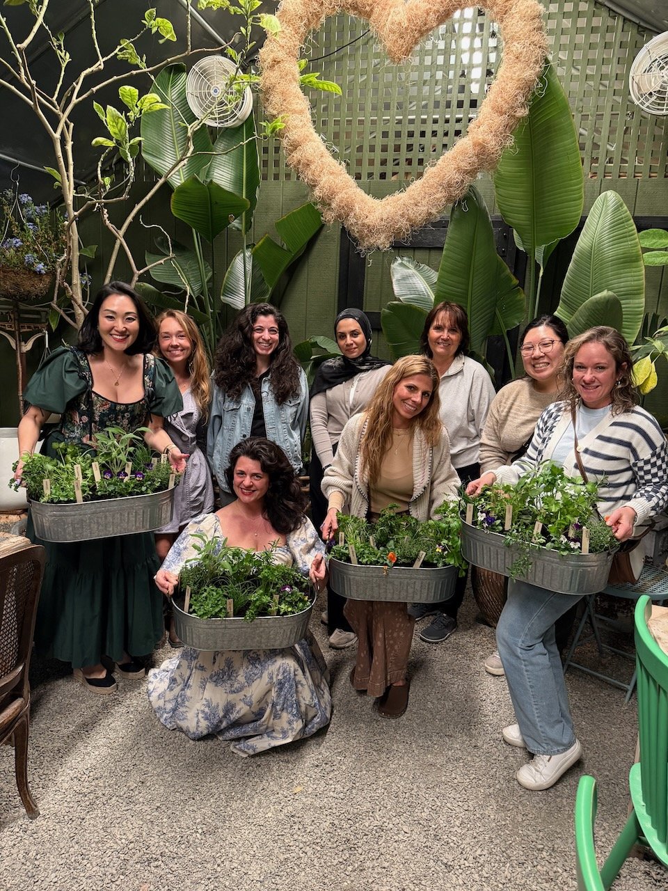 group of women with mini herb gardens they planted at an herb workshop by The Backyard Garden Co at la serra gardens
