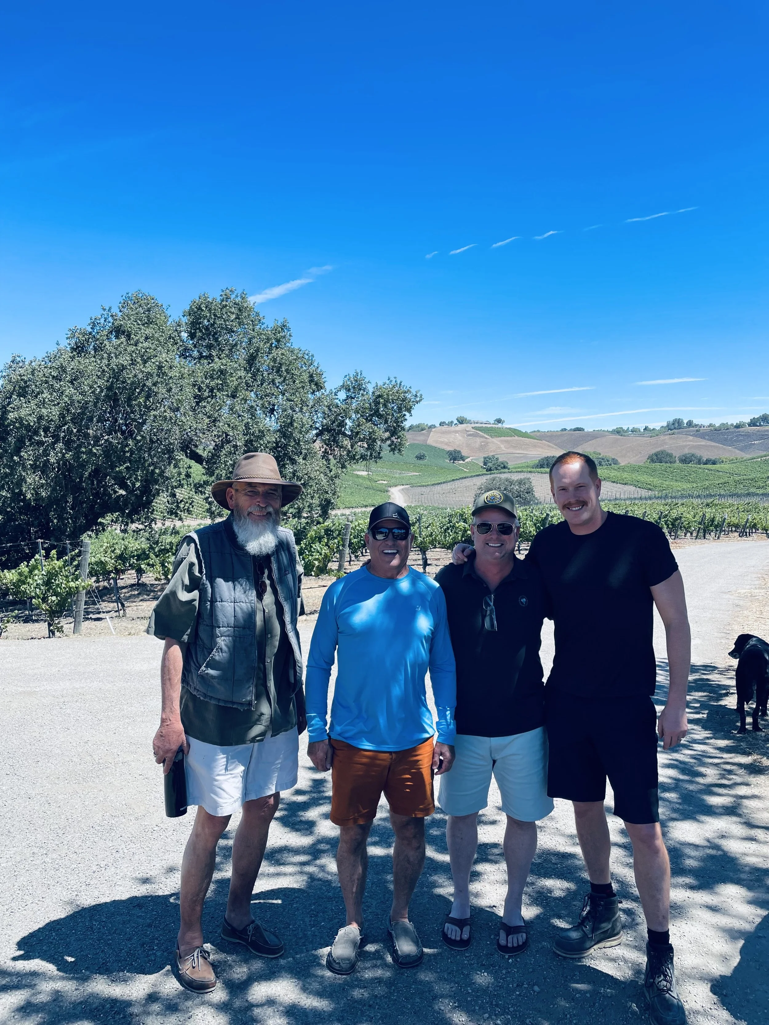 Tom Stolpman, Peter Neptune, Peter Baedeker and Peter Stolpman standing at the Stolpman family vineyard