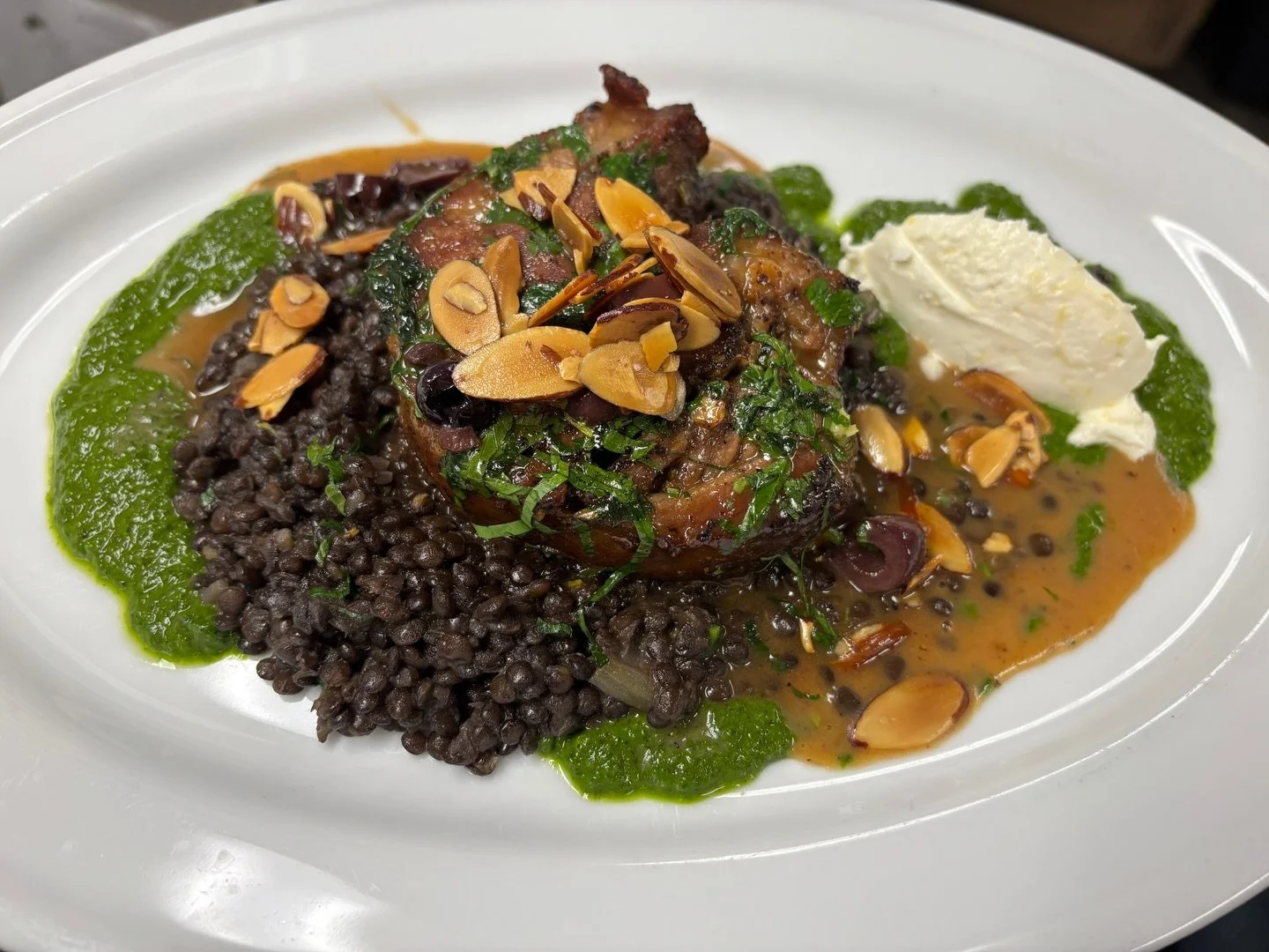 Roasted lamb shoulder! Served with cavolo nero salsa verde, black lentils, almonds, and lamb jus. WOW! Serving while supplies last 🍽️ &Ccedil;a a l&rsquo;air d&eacute;licieux!