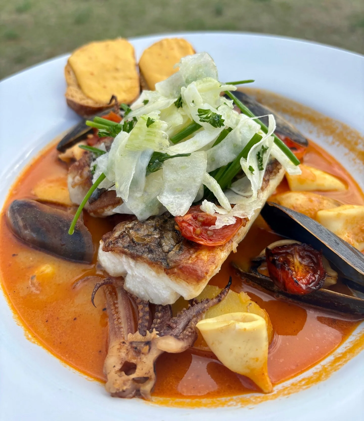 This weekend join us for Bouillabaisse! Oui, s&rsquo;il vous pla&icirc;t! 
Virginia striped bass with grilled squid, mussels, saffron rouille, and new potatoes. 🍅 While supplies last 🍅