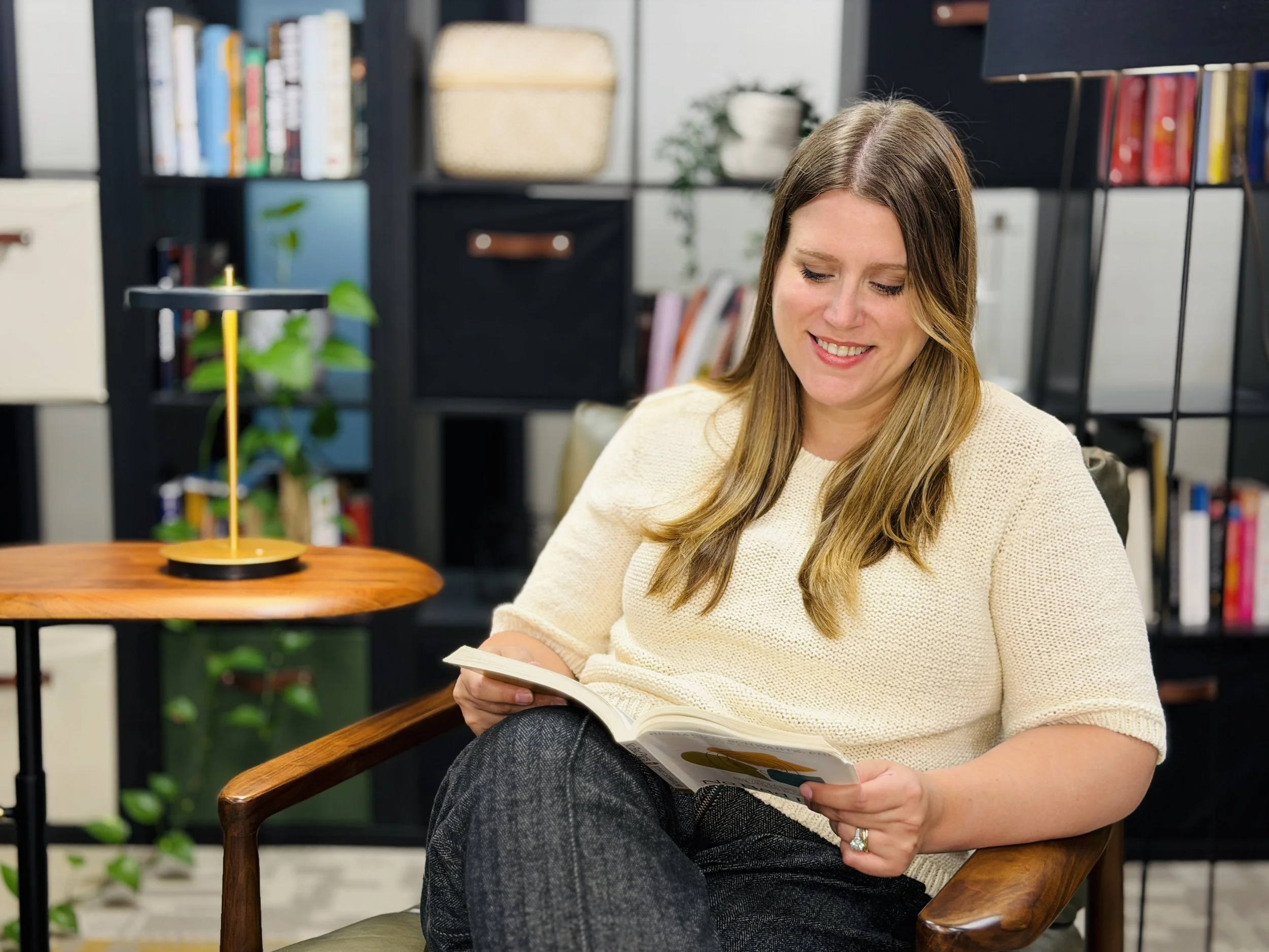 Shannon Theobald, LPC reading about therapy and coaching at Thrively Co. in the office in Parsippany, NJ