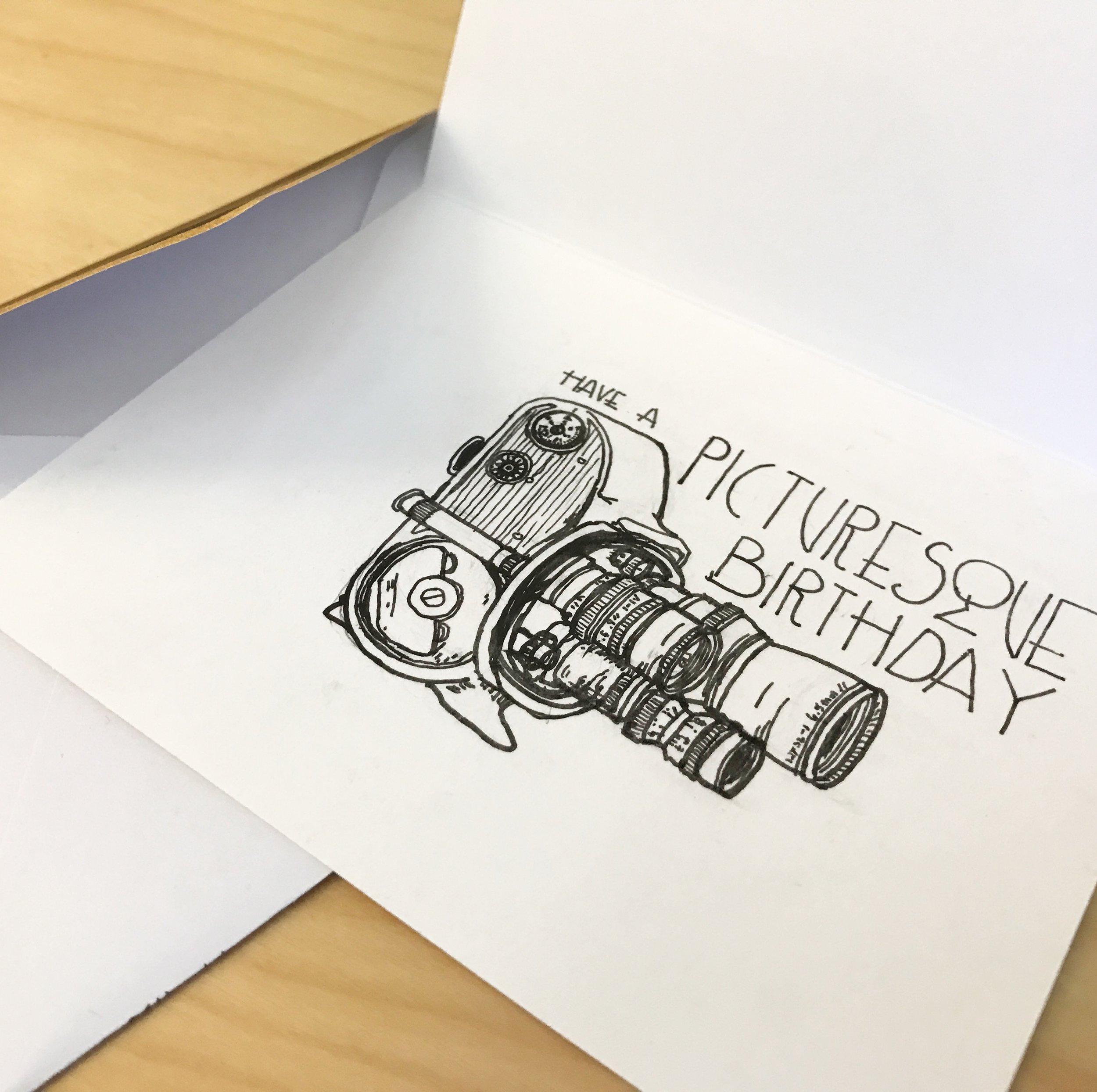 An antique three lens 8 millimeter film camera with caption Have a Picturesque birthday
