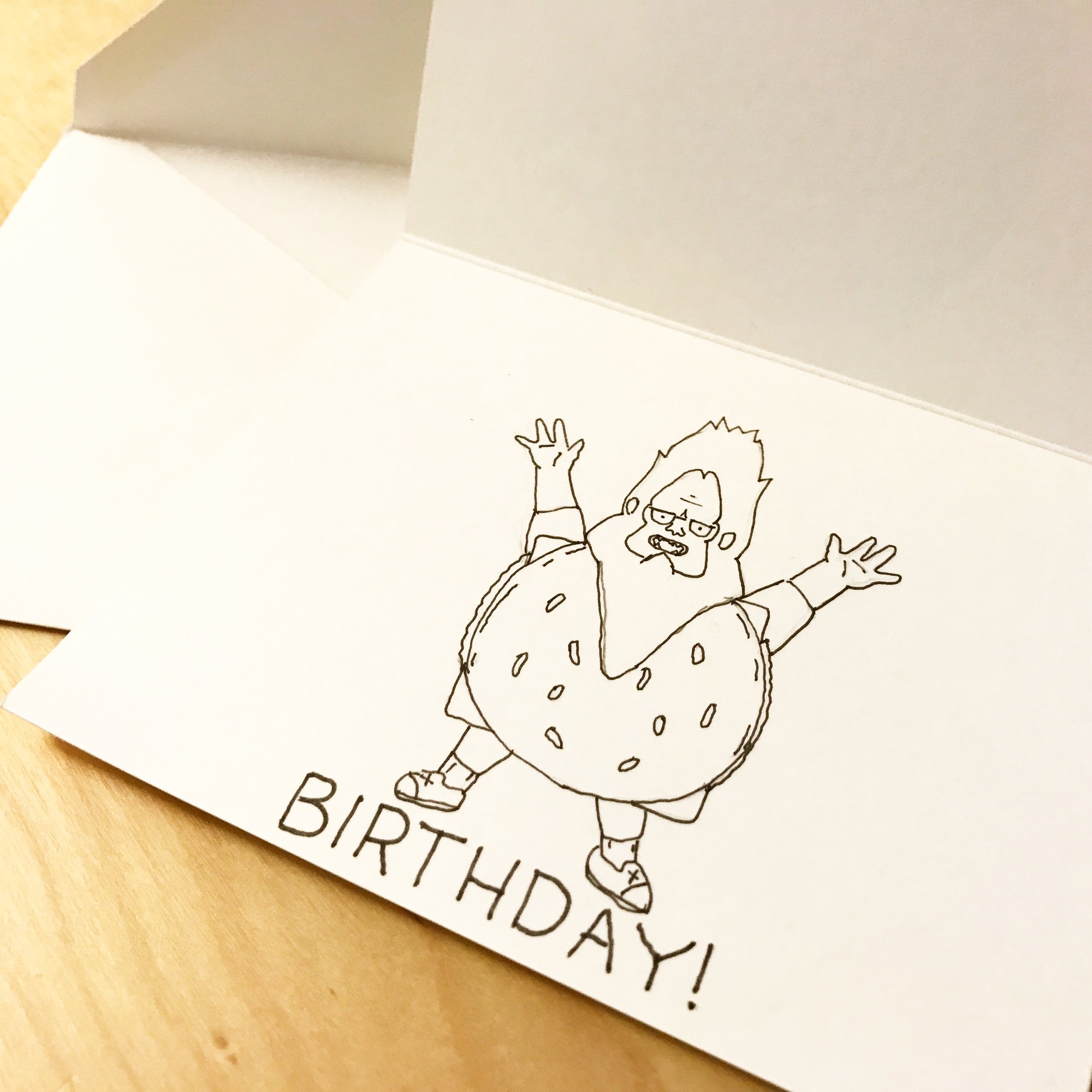 Eleven year old Gene Belcher from the televesion show Bob's Burgers is dressed as Beefsquach with arms raised and caption "Birthday!" The costume is a full body cheeseburger outfil paired with a sasquach mask