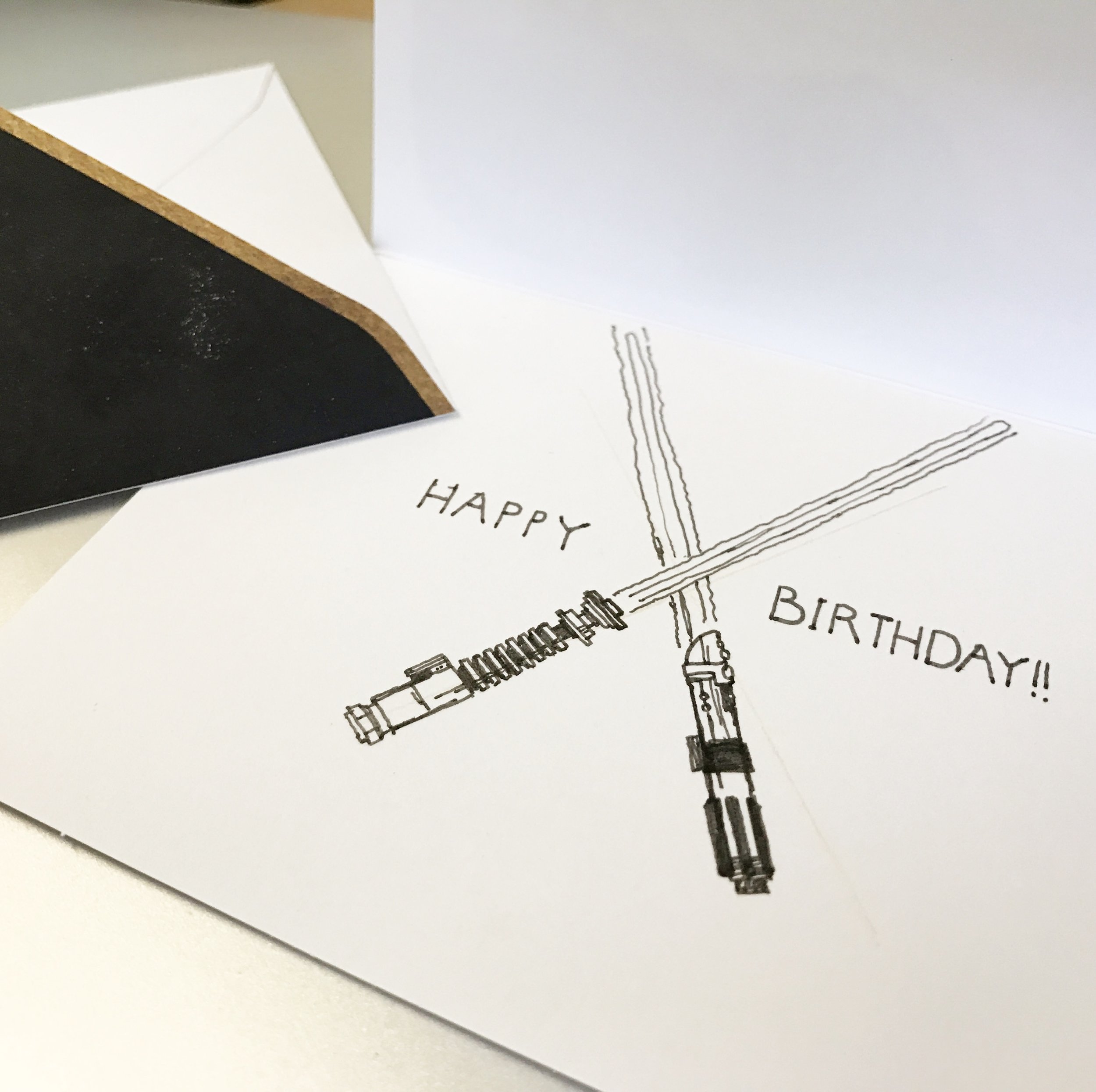 Two crossed lightsabers with the caption Happy Birthday