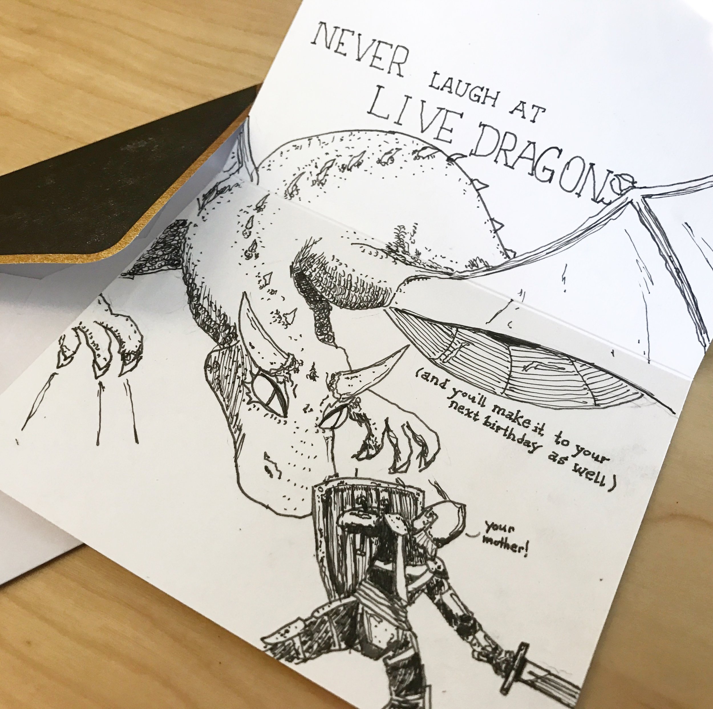 A knight in armor and helm is seen from behind holding a shield and sword and faces a large dragon with a caption Never Laugh at Live Dragons. In paratheses and you'll make it to your next birthday as well. The knight is exclaiming Your Mother!