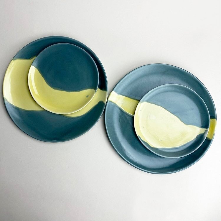 Painterly place settings for two. Each plate is glazed in satin slate with a streak of gold, reminiscent of a moonbeam on water. available on gleena.com.