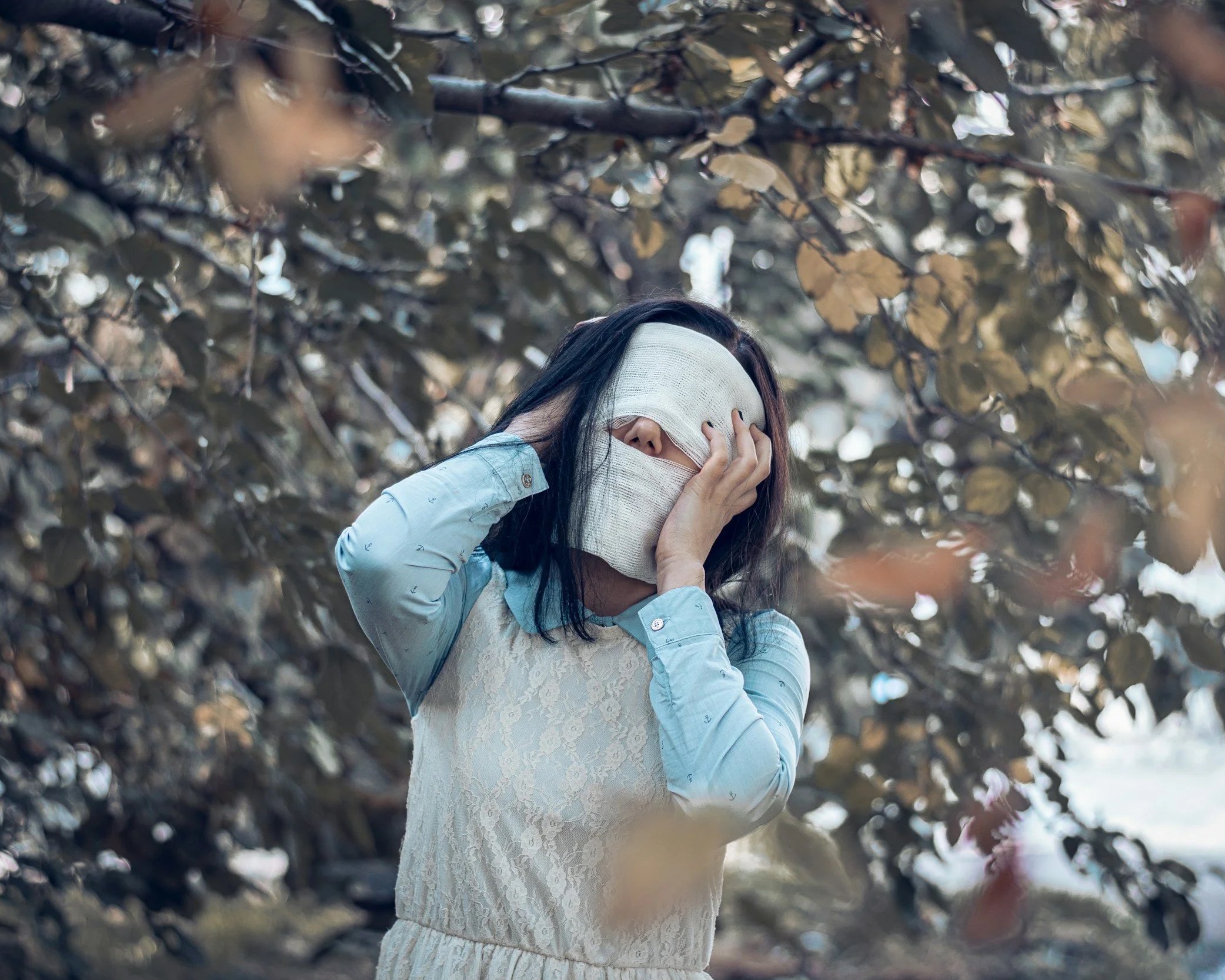 Woman covering her face representing confusion and self-doubt after gaslighting