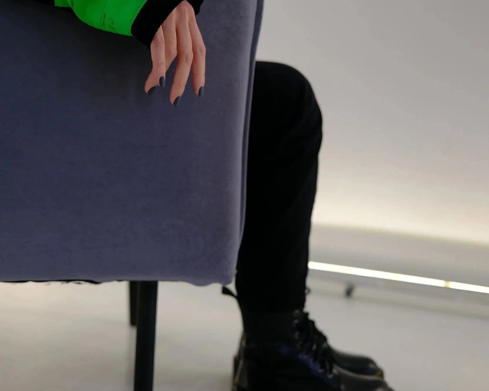 Person sitting quietly, body turned away, suggesting withdrawal