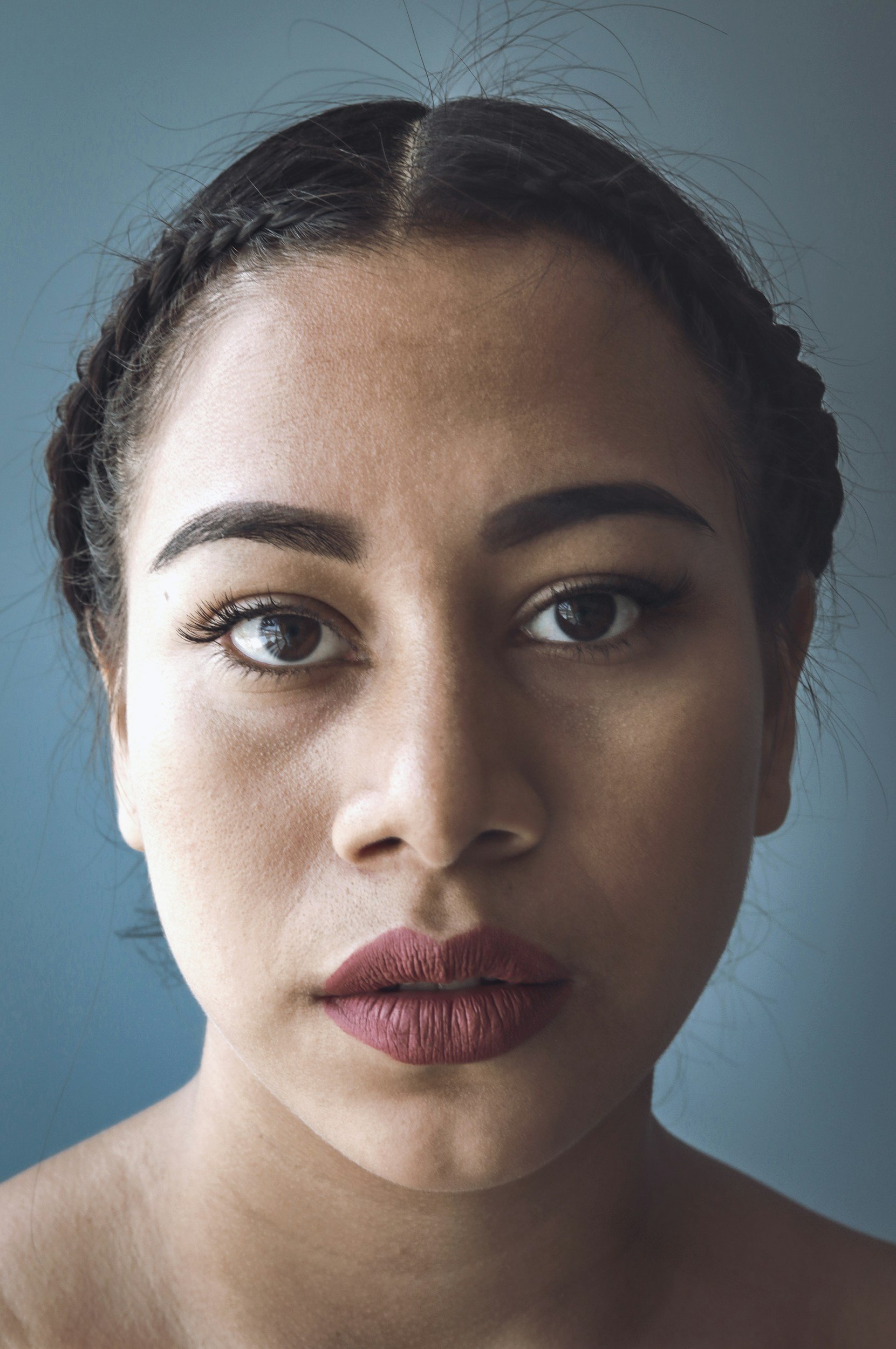 Close-up portrait of a woman with a calm but guarded expression.