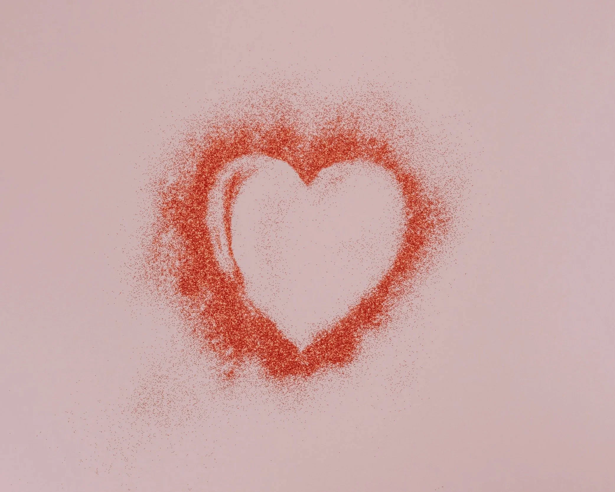 Heart shape sprayed onto a pale wall symbolising trauma bonding and emotional attachment.