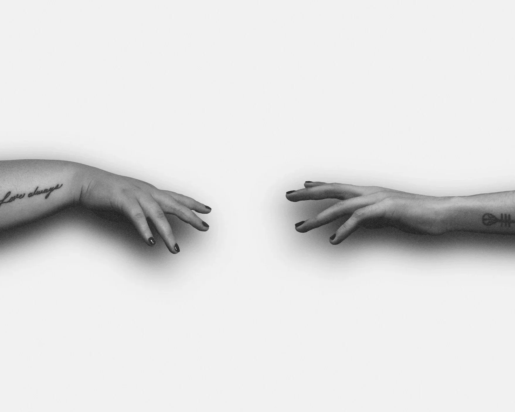 Two hands reaching toward each other but not quite touching