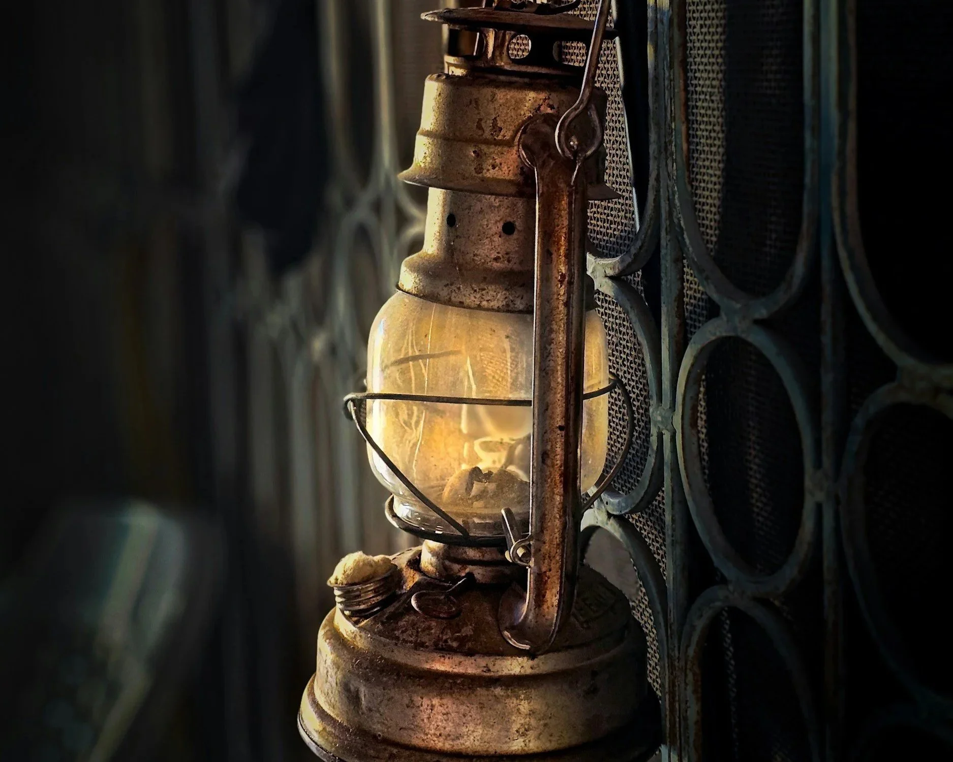 Old lantern casting light in a darkened space