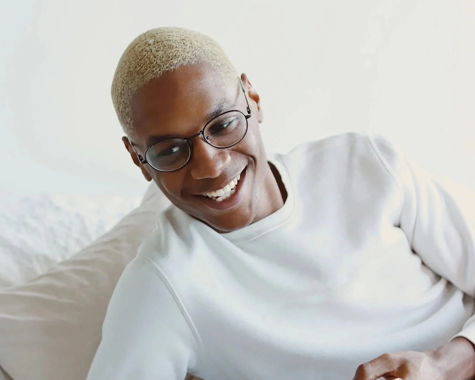 Person smiling while looking at a phone, representing subtle boundary crossings in relationships