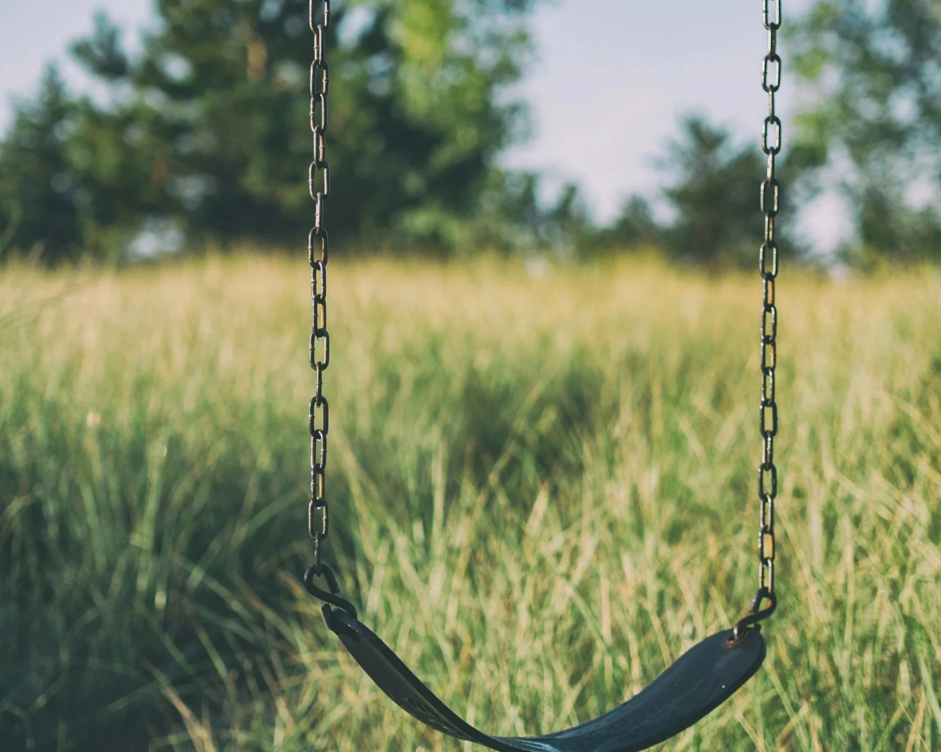 Empty swing in a quiet meadow