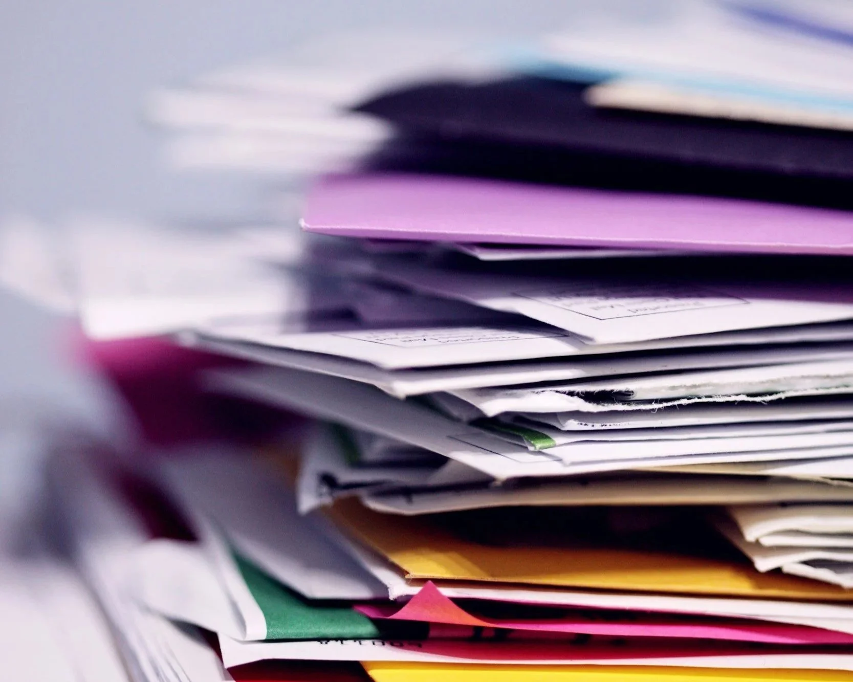 Stack of papers and unfinished tasks, representing overwhelm and avoidance
