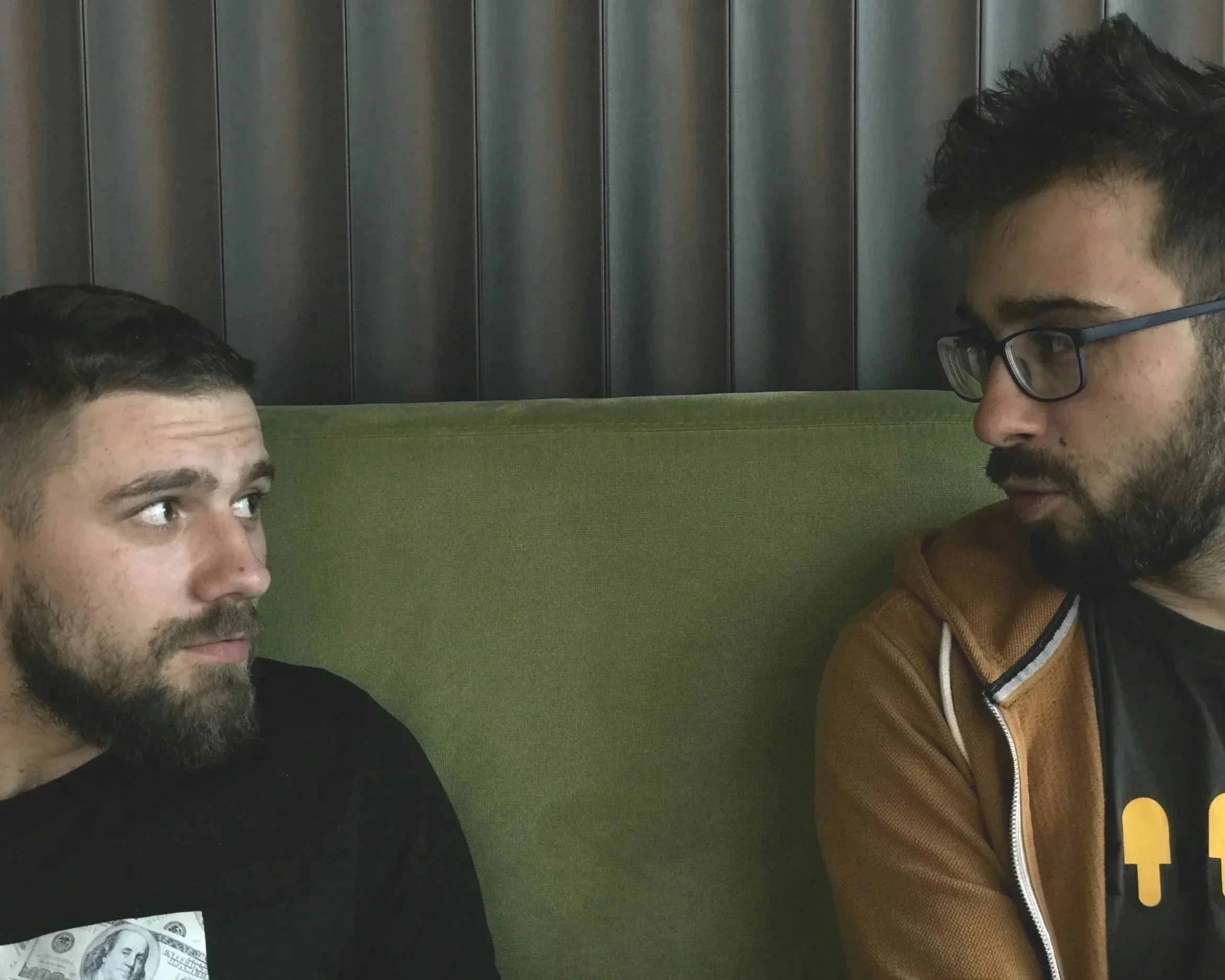 Two people sitting across from each other in difficult conversation