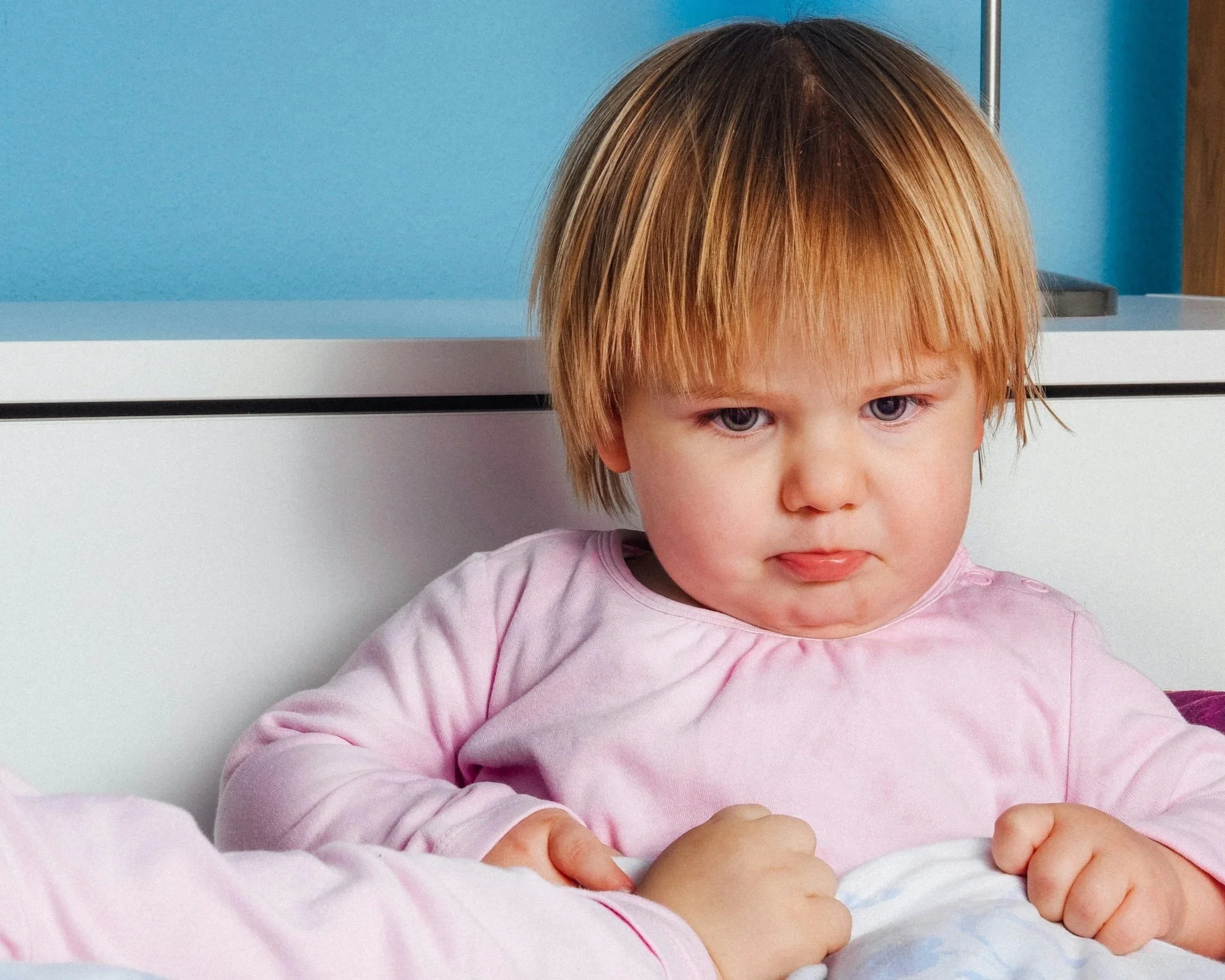 A young child looking frustrated, representing emotional overwhelm