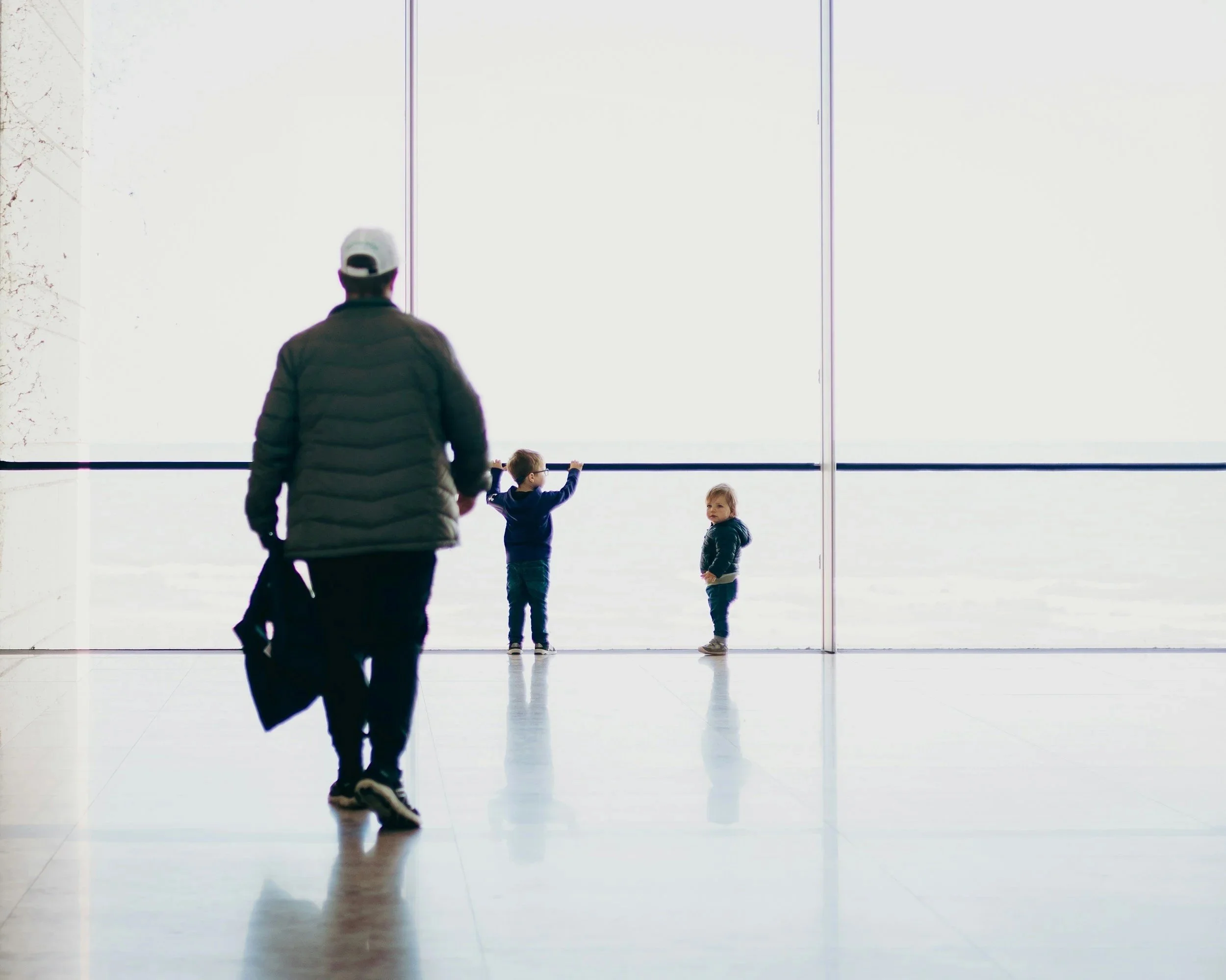 parent walking separately with children, representing low-contact co-parenting dynamics