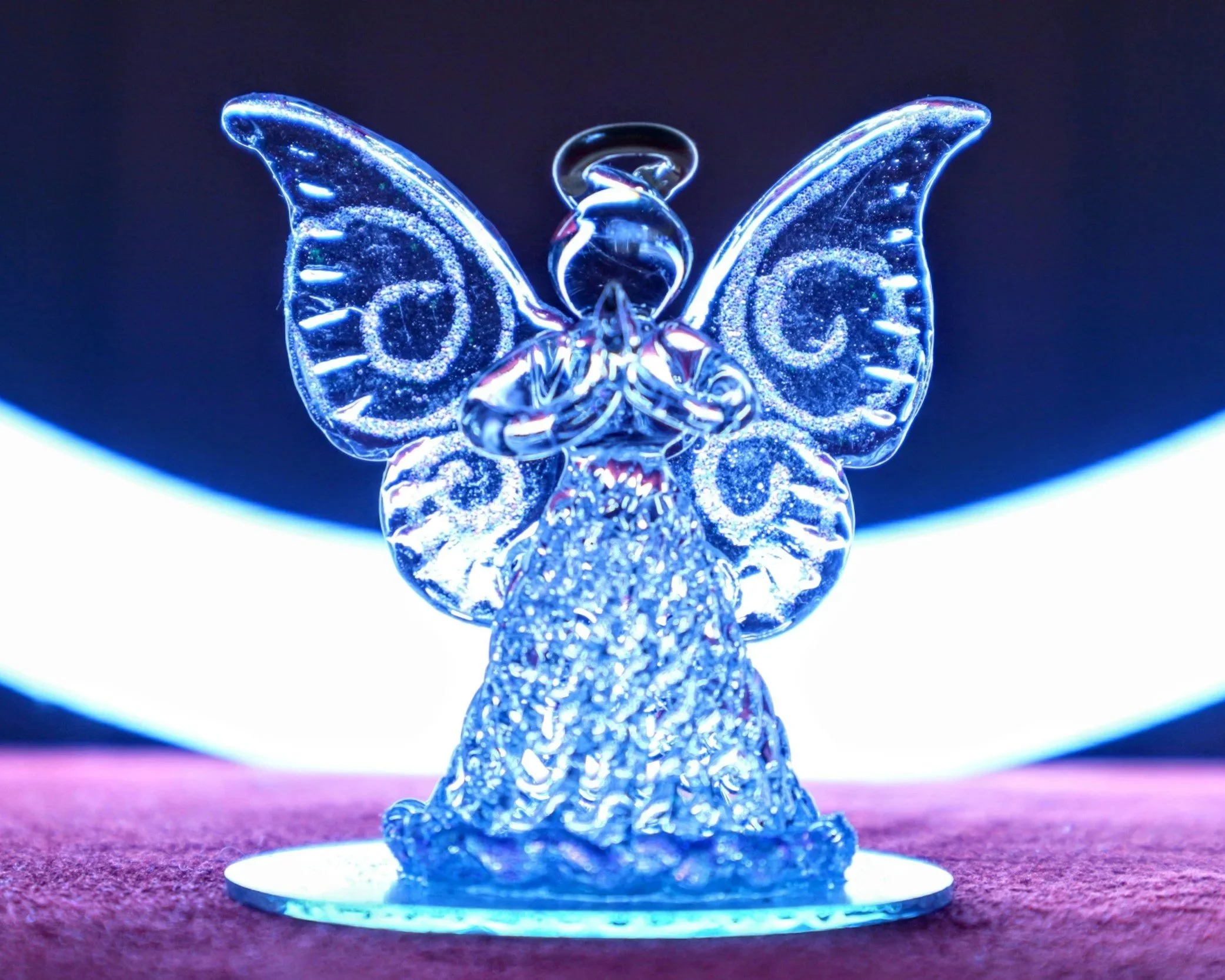Blue glass angel figurine shown against a softly lit background, representing the “glass child” metaphor of being overlooked while appearing fine.