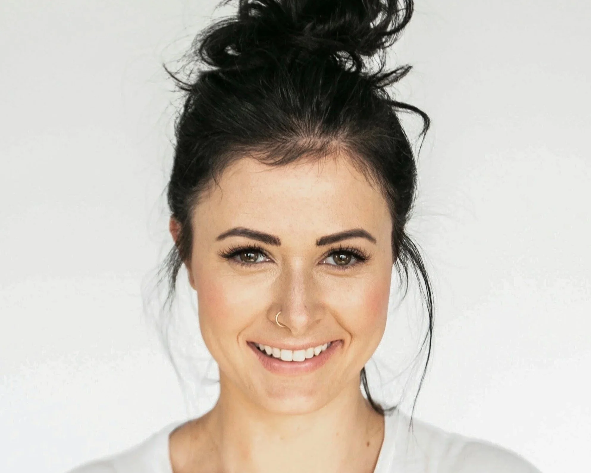 Woman smiling warmly, representing people-pleasing and seeking approval