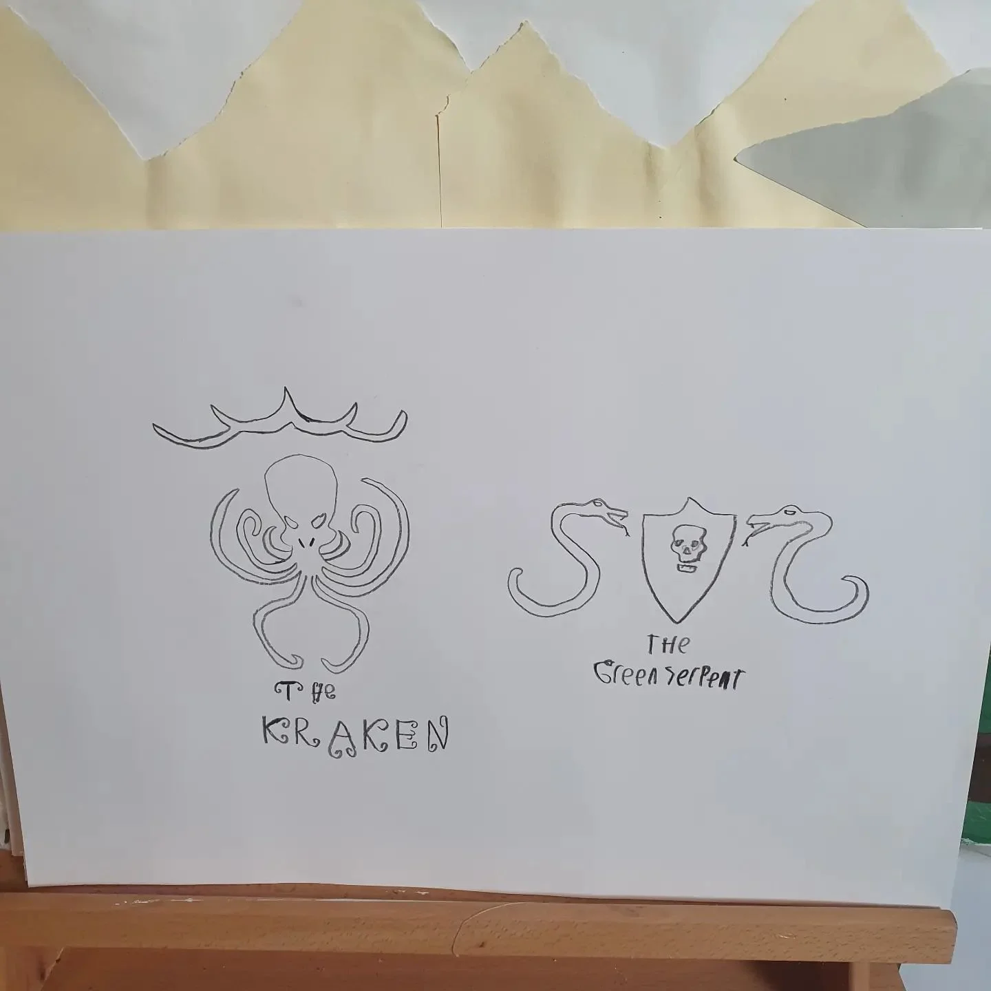 I have drawn the logos of the pirate ships. The Kraken. The Green Serpent. I've written the font with kraken tentacles.