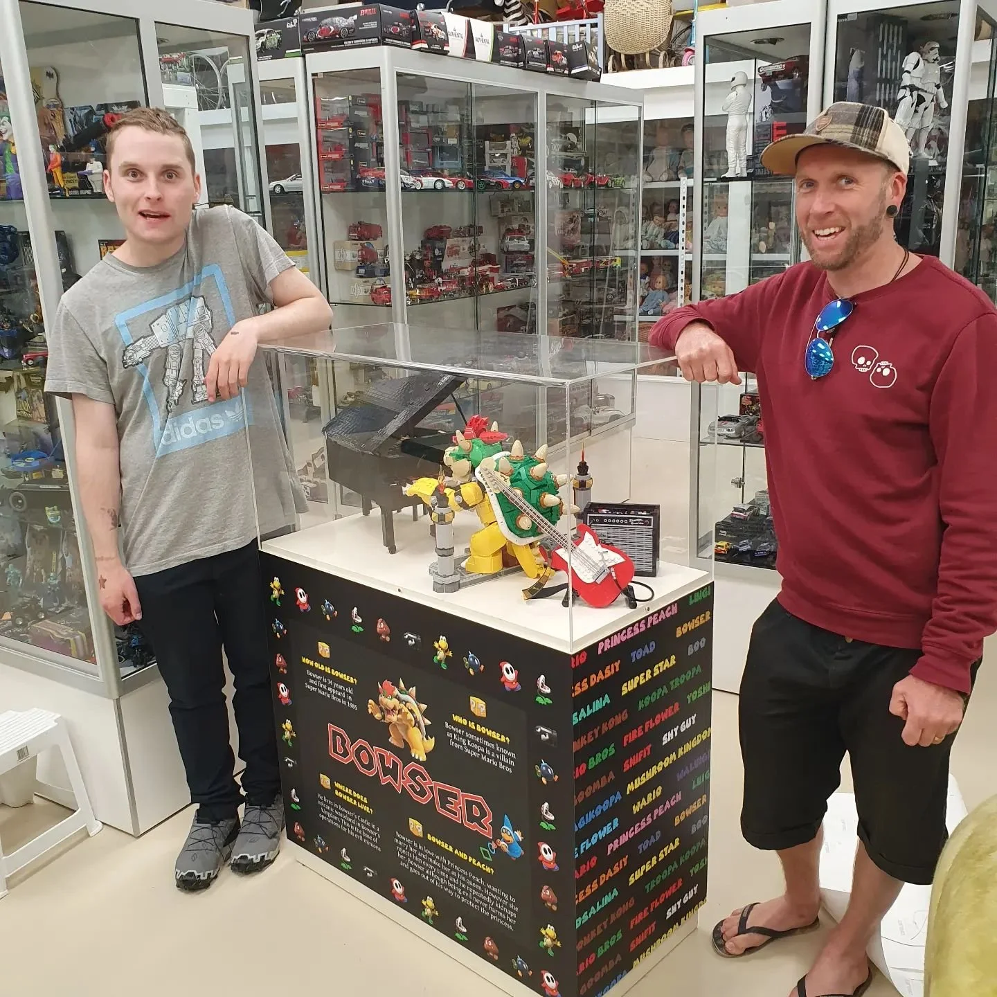 Adam and I are putting bower stickers on a display of lego bowser playing the piano. It's at the toy museum