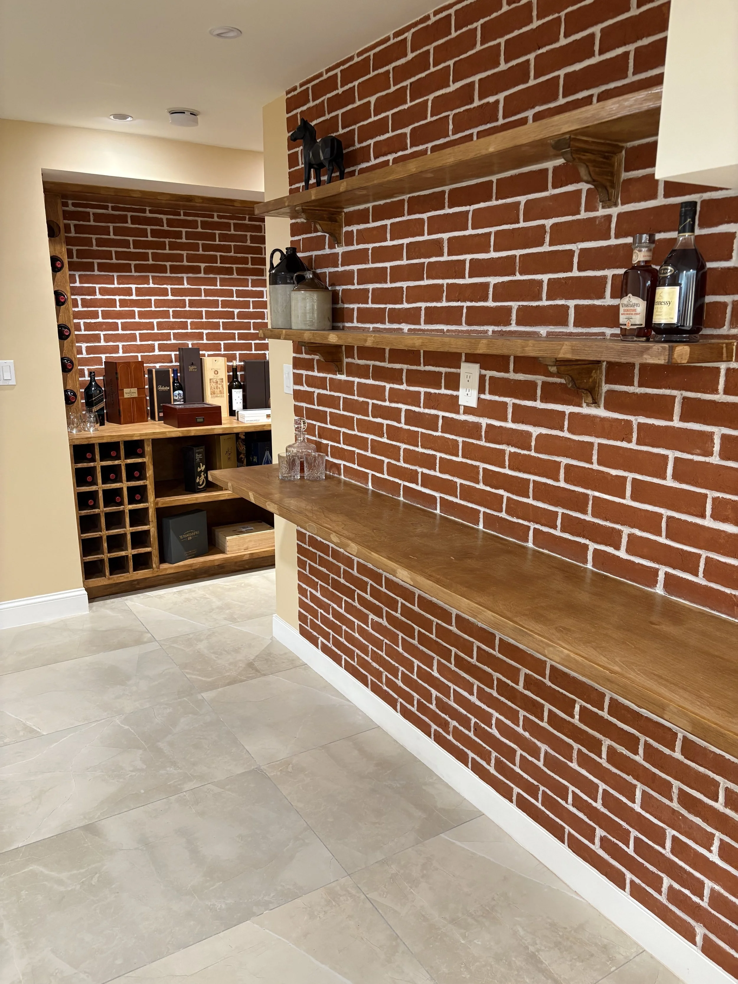 Custom basement wine cellar with brick accent wall — Plymouth, MA basement finishing by MSDG Construction