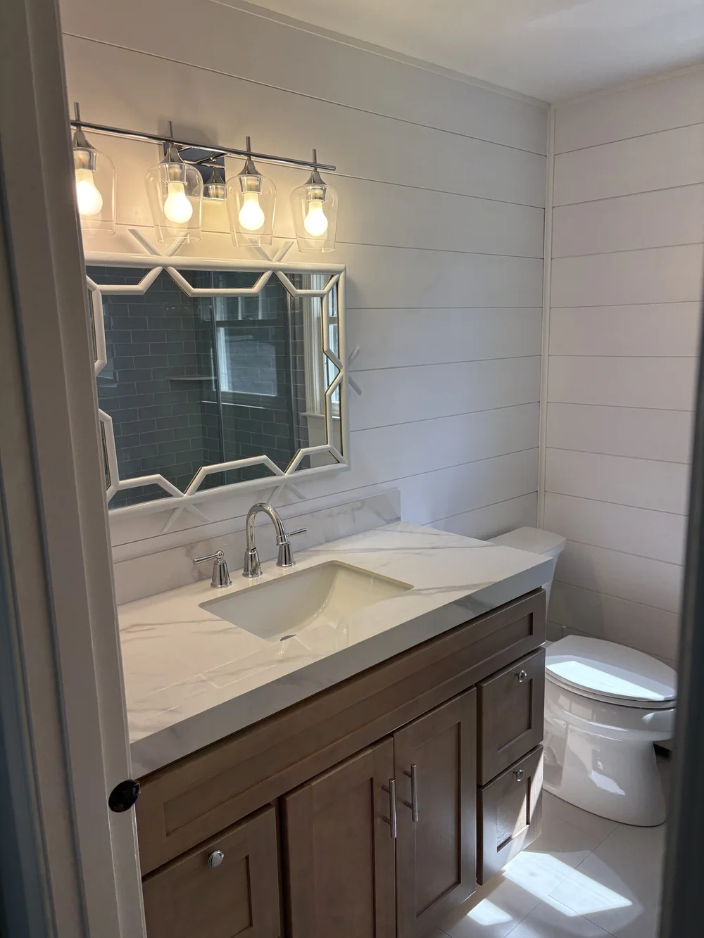 Bathroom vanity with mirror and shiplap walls in Kingston, MA remodel by MSDG Construction