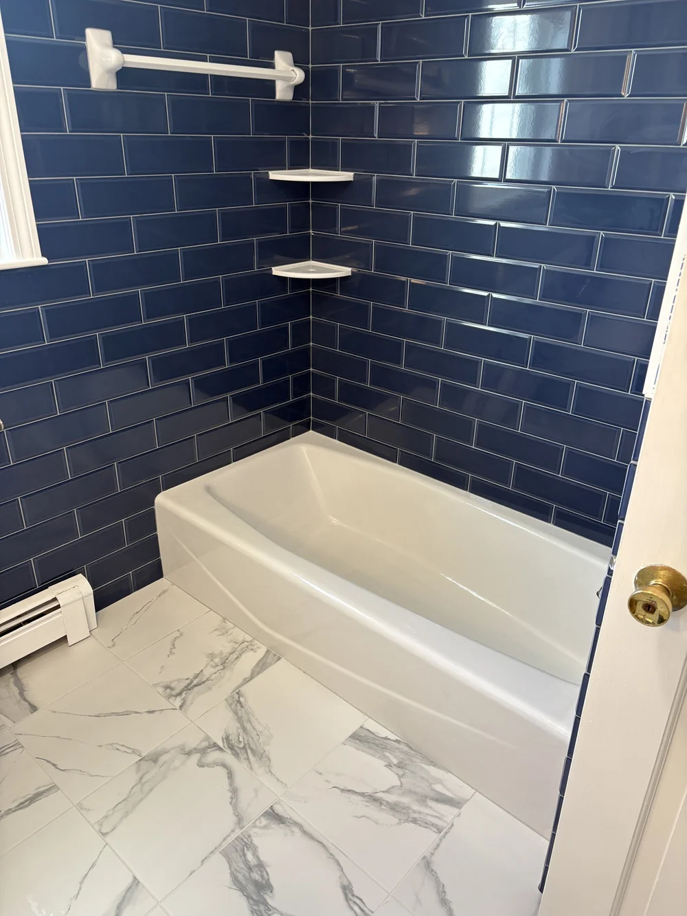 Plymouth, MA bathroom remodel with navy blue subway tile and white vanity by MSDG Construction