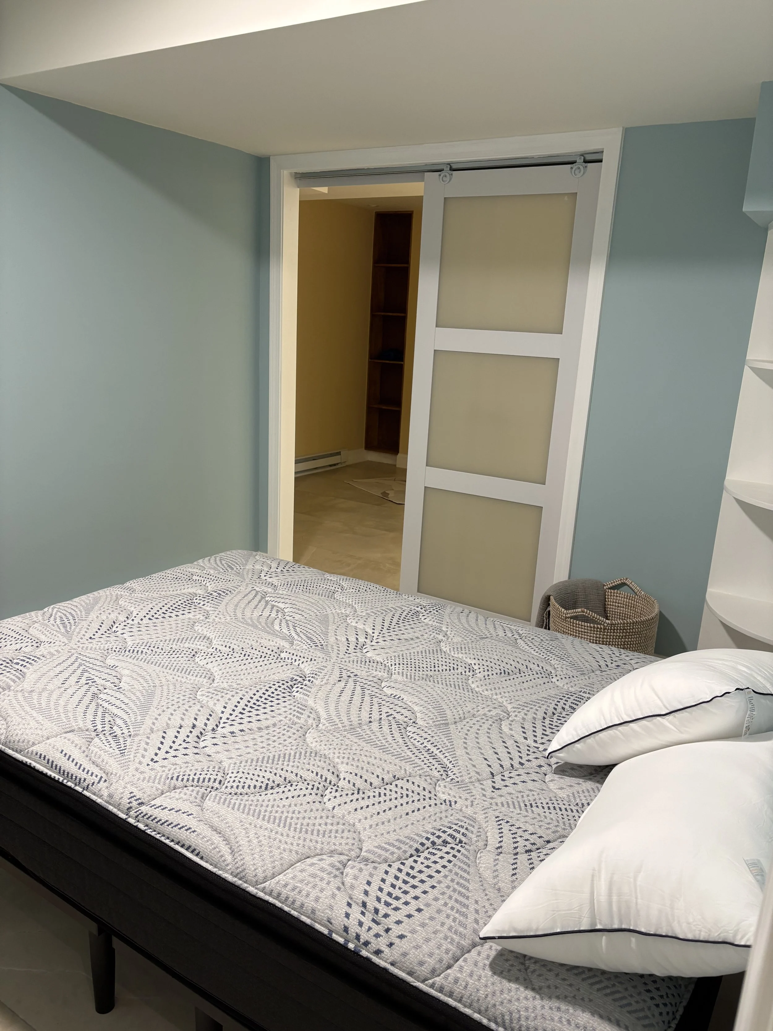 Basement guest bedroom with built-in closet — Plymouth, MA basement finishing by MSDG Construction