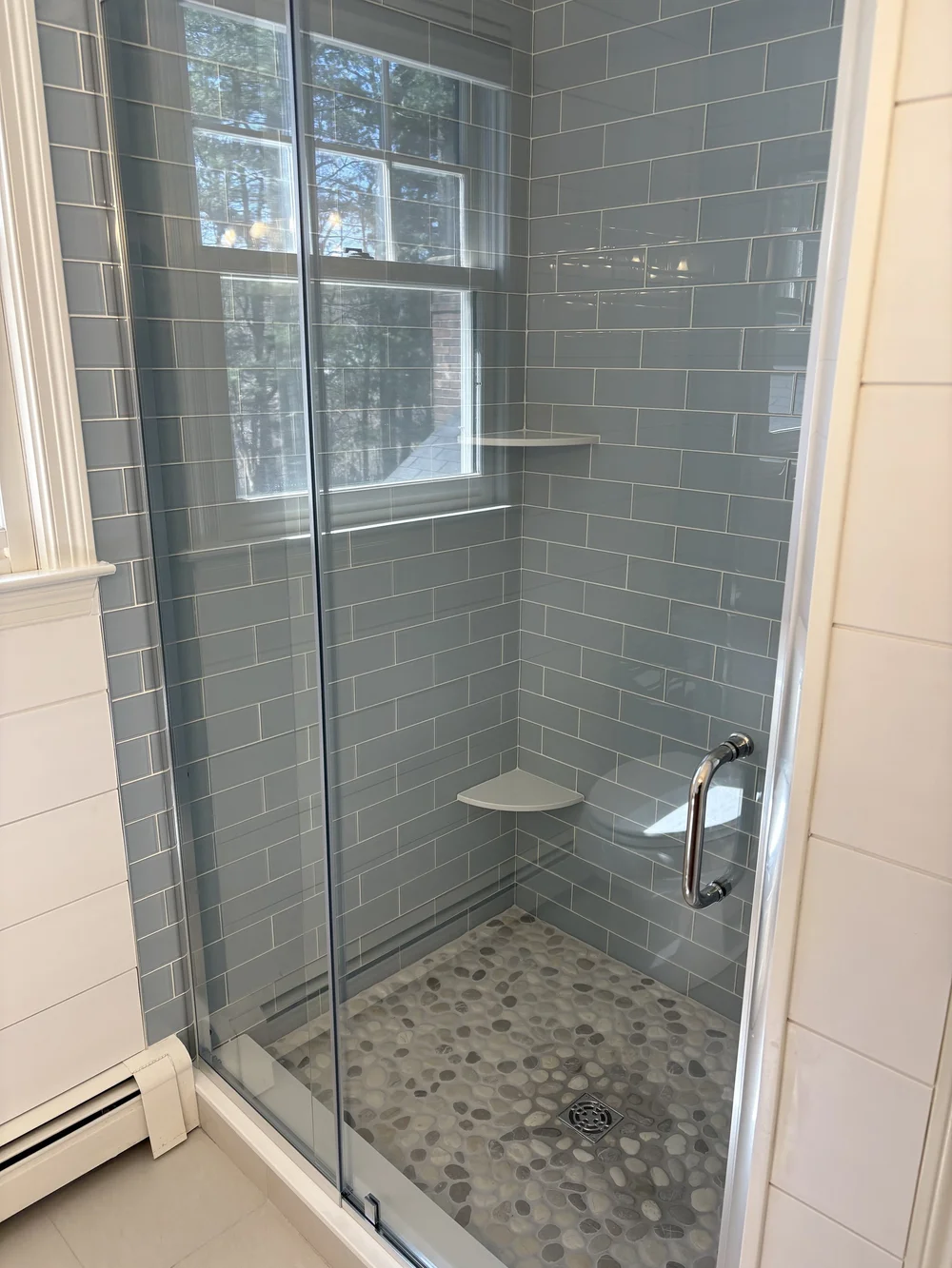 Walk-in glass shower with subway tile and pebble floor in Kingston, MA bathroom remodel