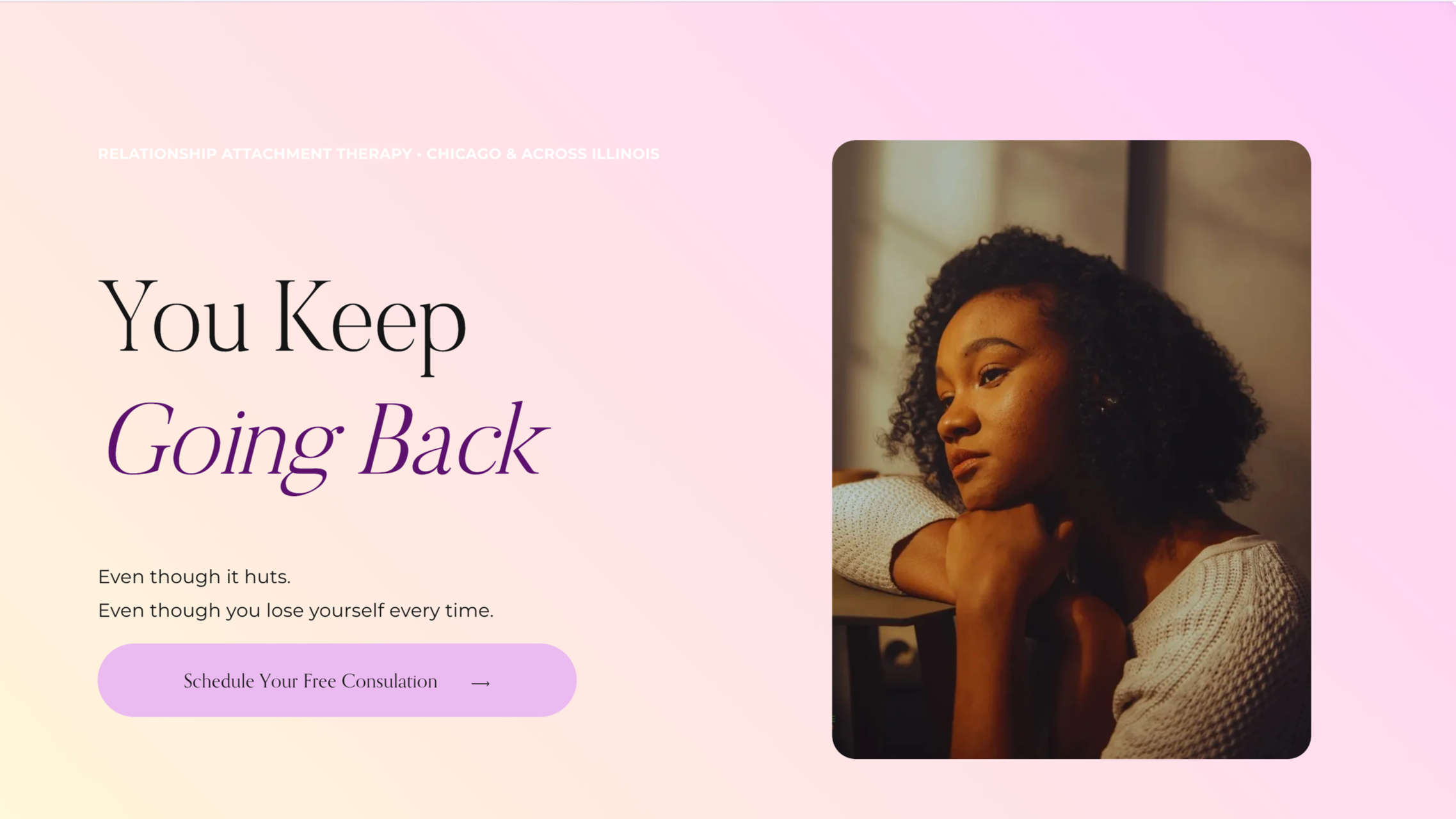 A woman with curly hair looks thoughtfully out a window, resting her chin on her hand, in a warmly lit room.