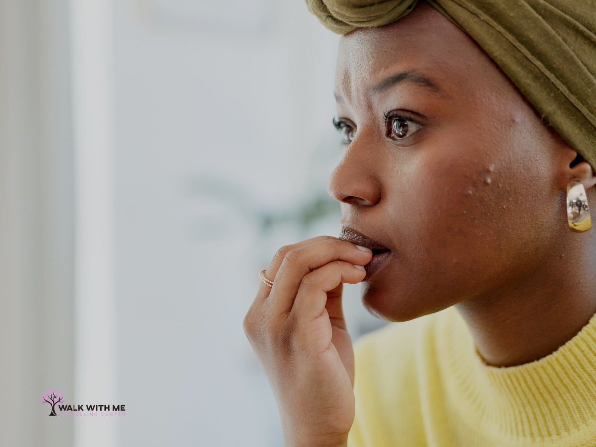 Person sitting quietly alone, disengaged and withdrawn, during a stressful moment