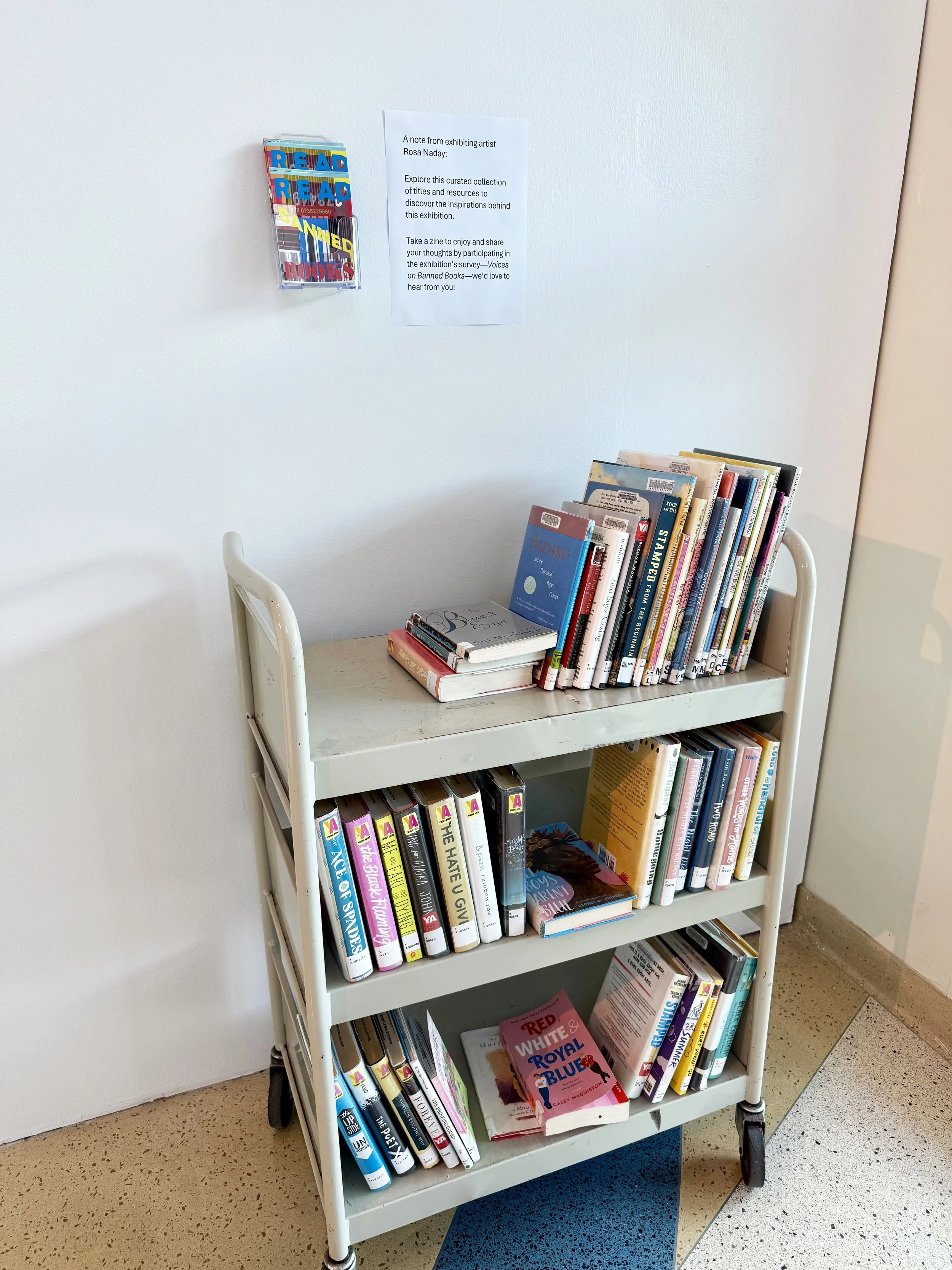 A curated book cart invites visitors to explore the titles and resources that inspired the exhibition. Take a zine to enjoy and share your thoughts by participating in our survey—Voices on Banned Books