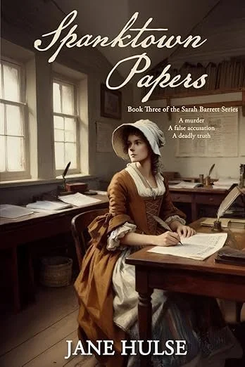 The book cover of 'Spaktown Papers' by Jane Hulse, featuring a woman in historical clothing sitting at a desk inside a room illuminated by natural light from two windows.
