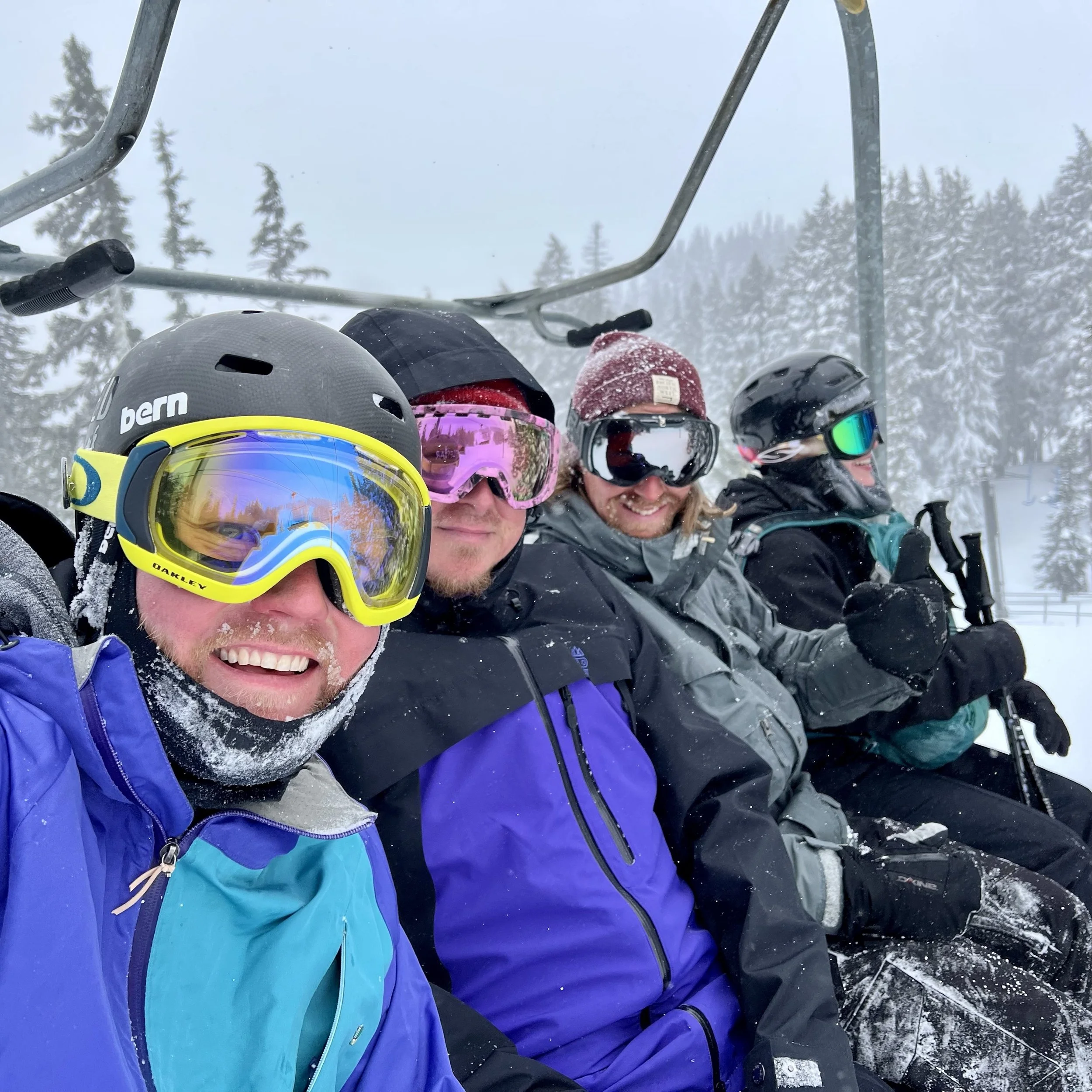 Friends skiing, sitting on a chairlift