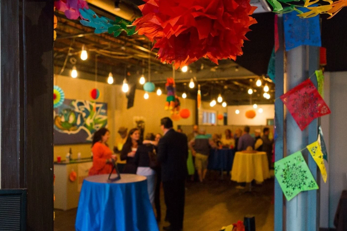 Colorful indoor party with decorations and people socializing