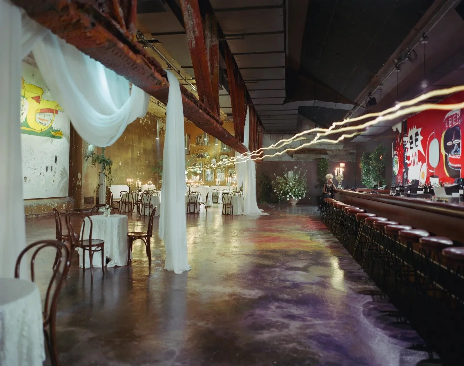 Inspired by Cocteau, the Mike Todd Room was a place for VIPs to carouse and schmooze, and enjoy a cabaret performance. At the back of the bar, a massive Basquiat mural is featured.