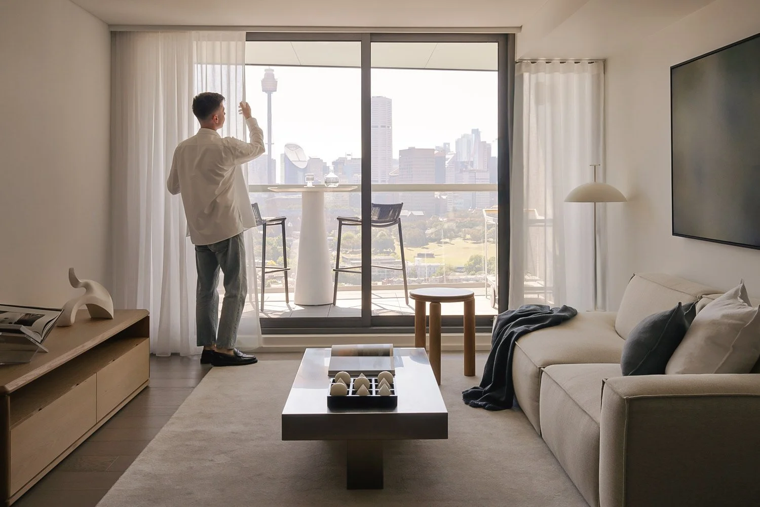 Interior stylist Rory James Carter in a styled Barangaroo apartment with Sydney CBD views
