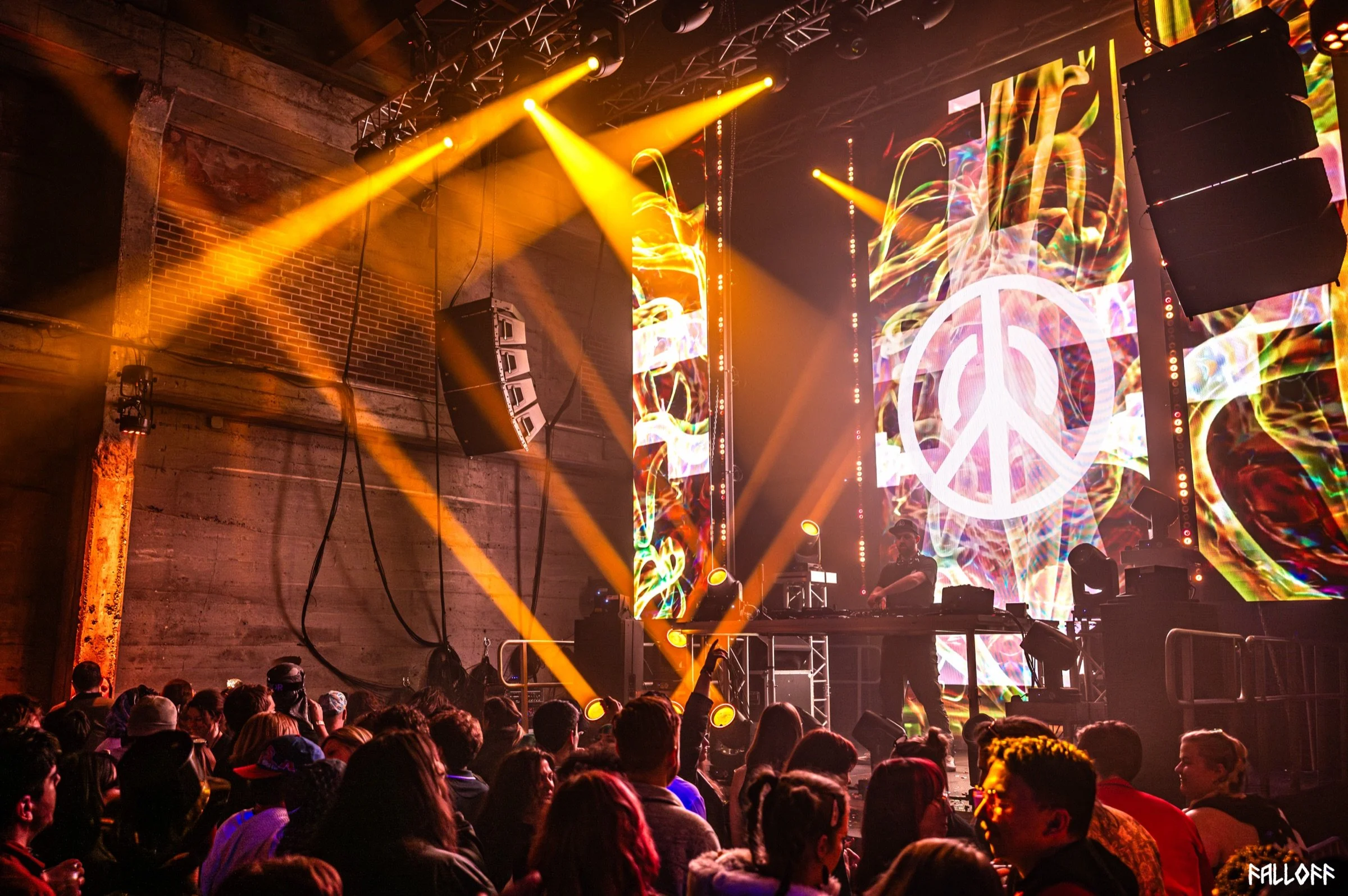 Given Peace onstage with the peace-logo visual — photo by Falloff Pix Media