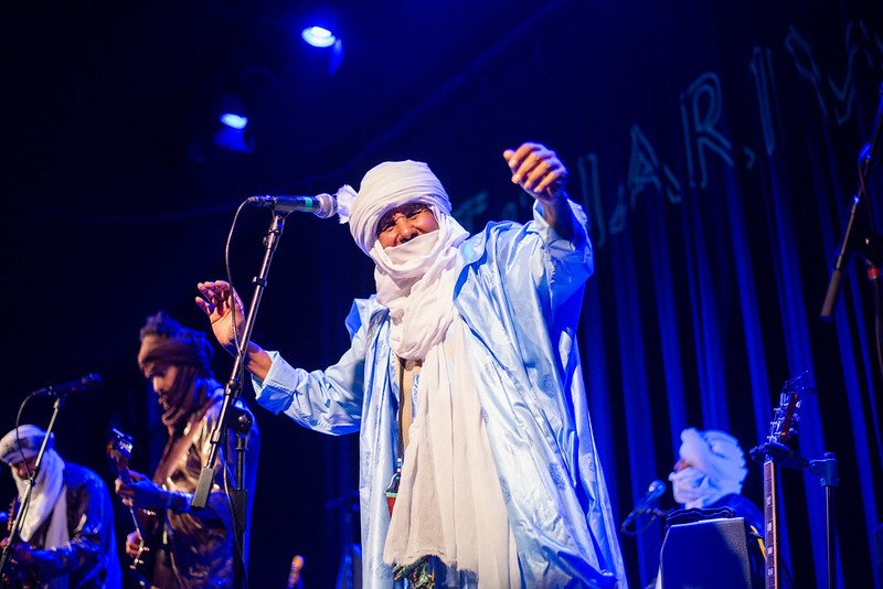 Celebrating Global Music, Building Cultural Connection 🌍🎶
Day 5: Tinariwen 
Hailing from the Sahara Desert in northern Mali, Tinariwen are pioneers of Tishoumaren&mdash;the &ldquo;desert blues&rdquo; sound blending Tuareg poetry, hypnotic guitar ri