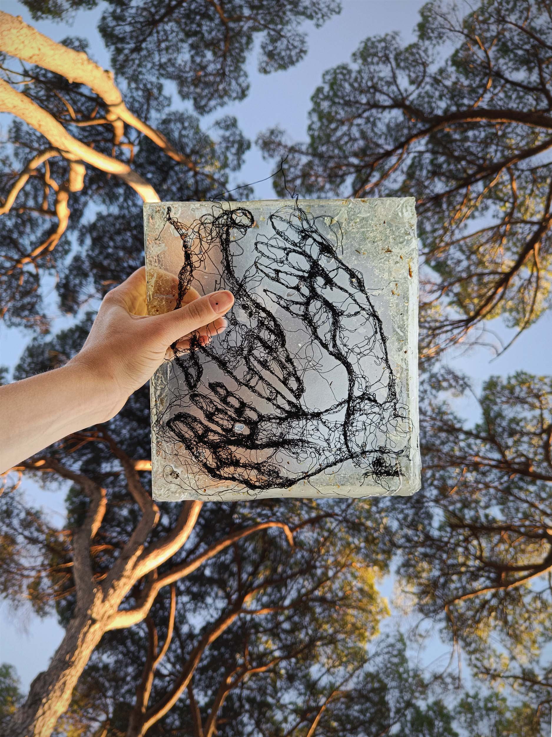 Sculpted epoxy resin with embedded cotton thread embroidery
