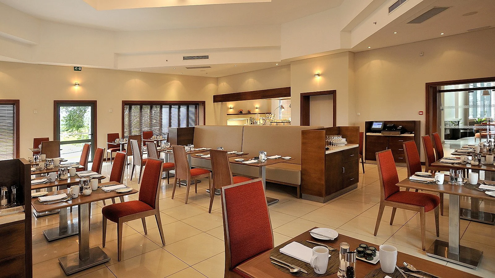 Completed restaurant interior showing dining tables, buffet service areas and coordinated hotel finishes.